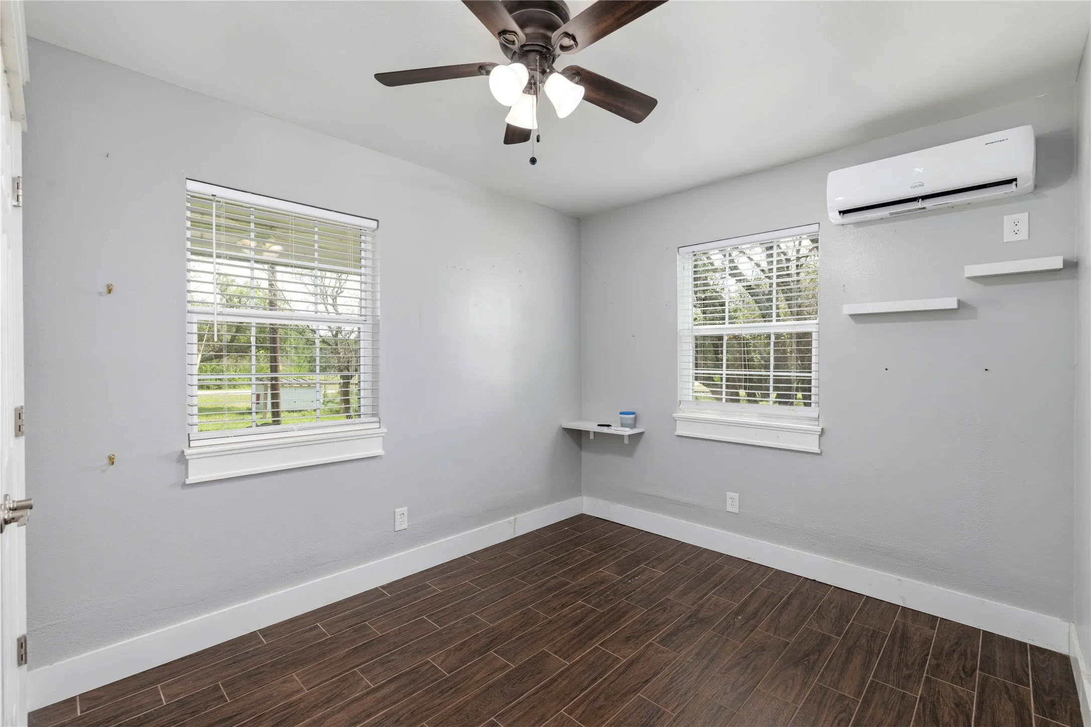 Interior space featuring wood-look flooring, light gray walls, and white trim