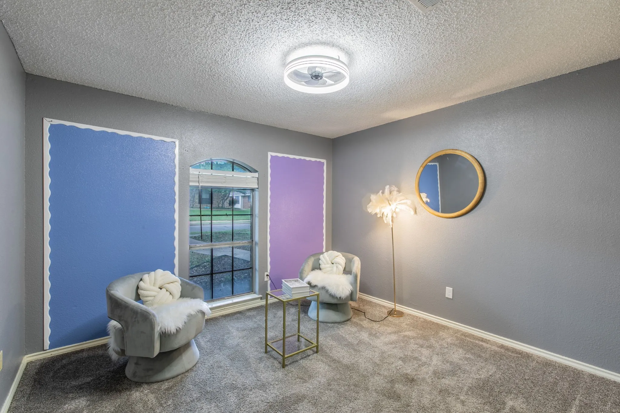 Windowed room featuring textured gray walls, a textured ceiling, and gray carpeting