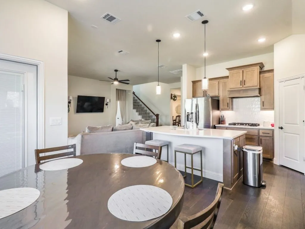Dining area featuring dark wood-type flooring, ceiling fan, and recessed lighting
