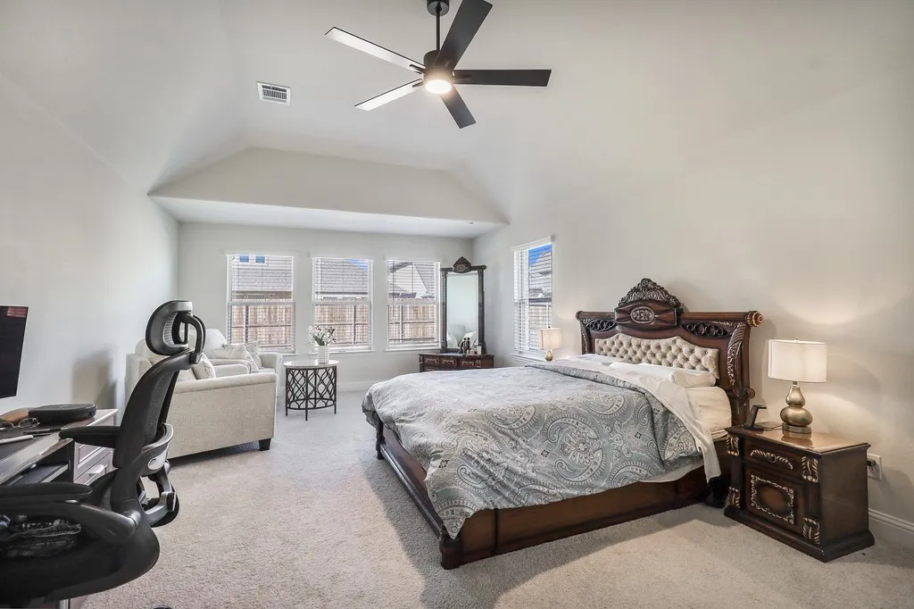Bedroom featuring carpet flooring, a ceiling fan, and lofted ceiling