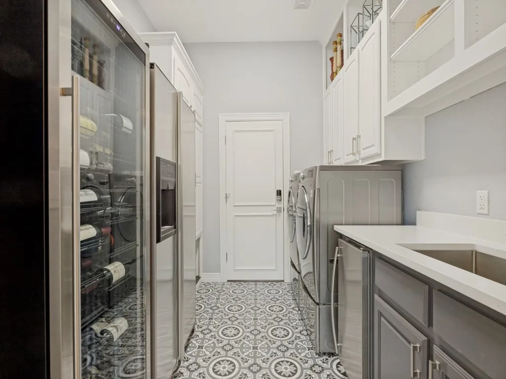 Reimagined utility is lovely and very functional with second door to garage and built-in icemaker.