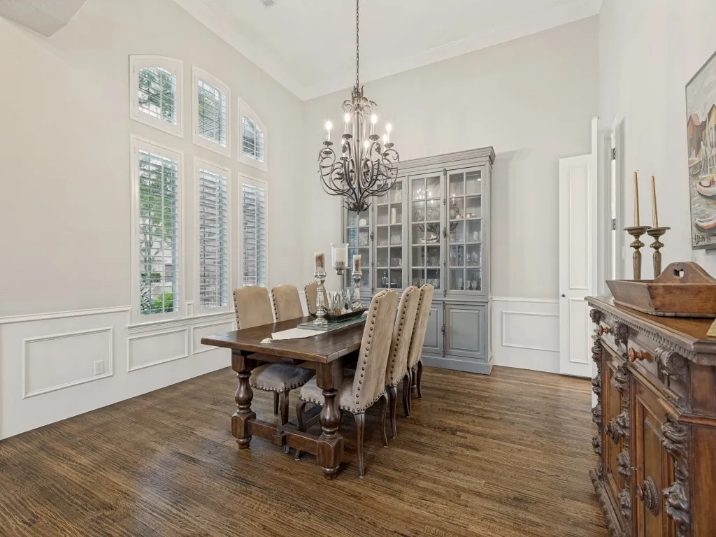Magnificent formal dining with plantation shutters and door to kitchen.