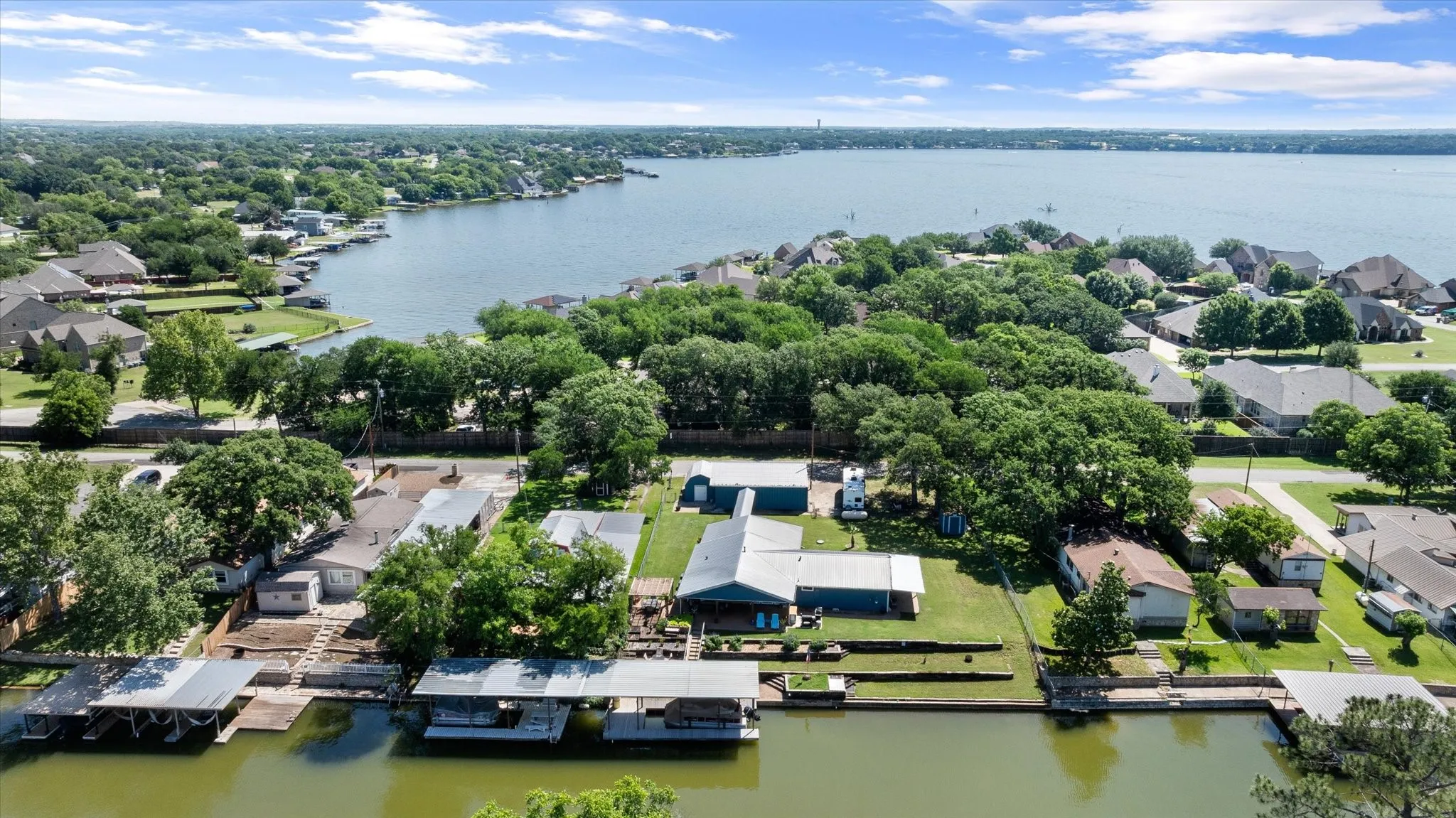 Waterfront property featuring multiple covered boat slips and direct water access