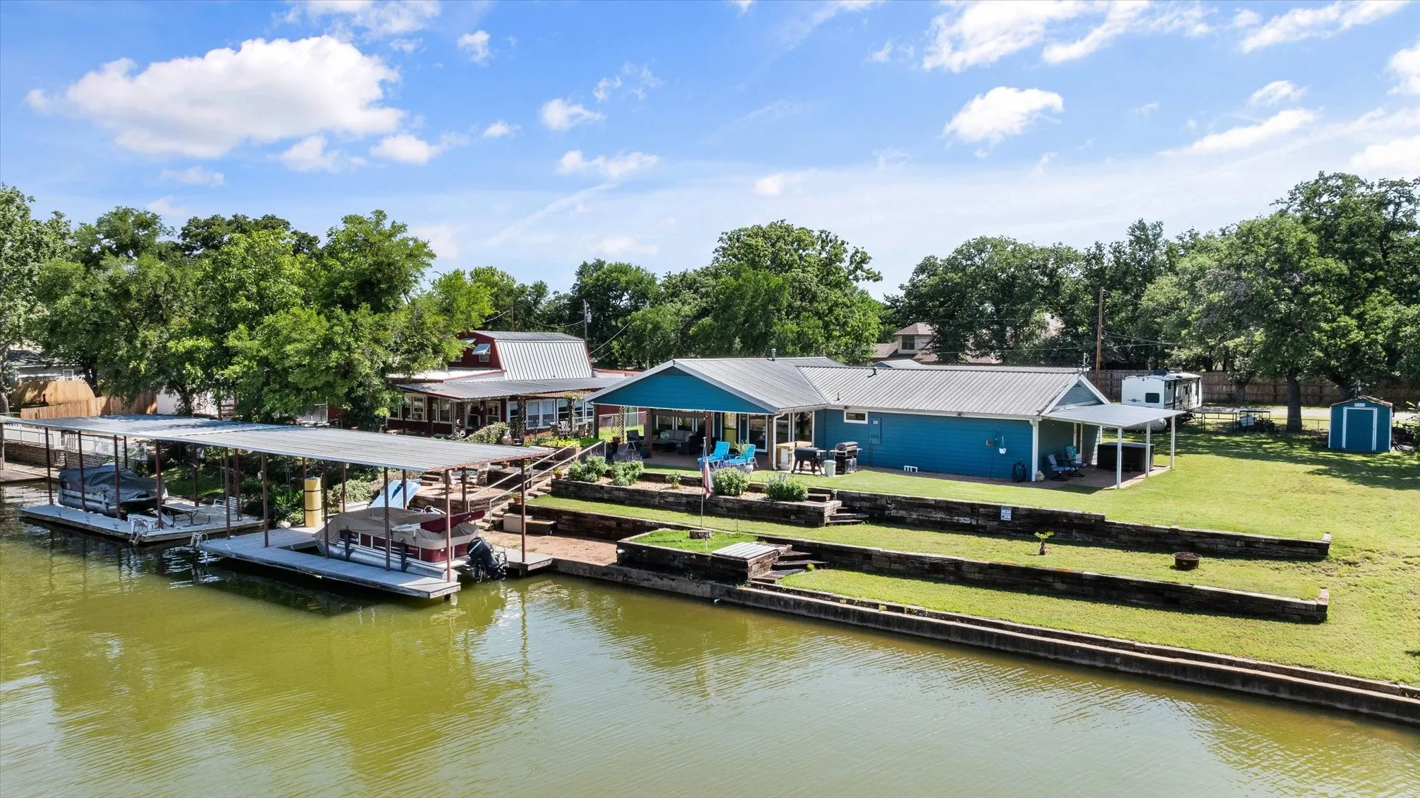Waterfront property featuring a private boat dock with multiple slips and covered berths