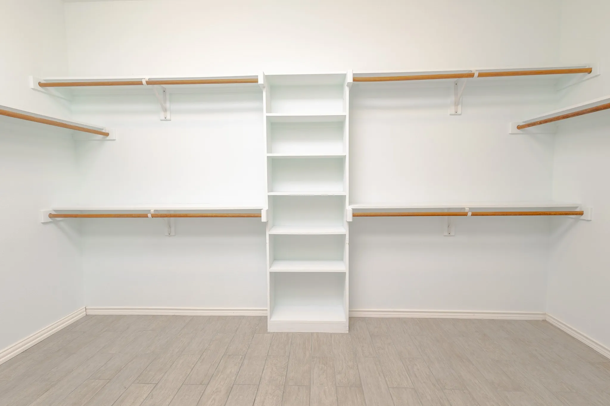 Walk in closet featuring light hardwood / wood-style flooring