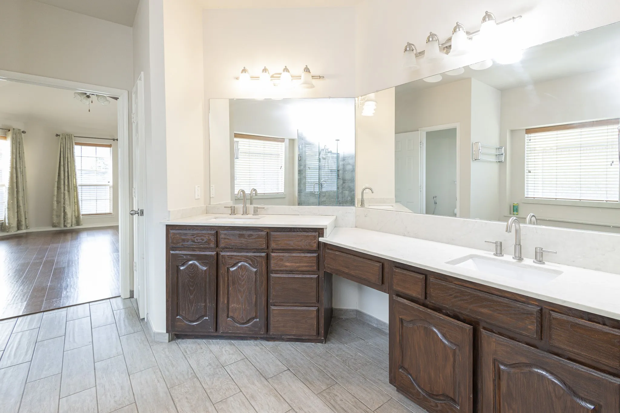 Bathroom featuring dual vanity and wood-type flooring