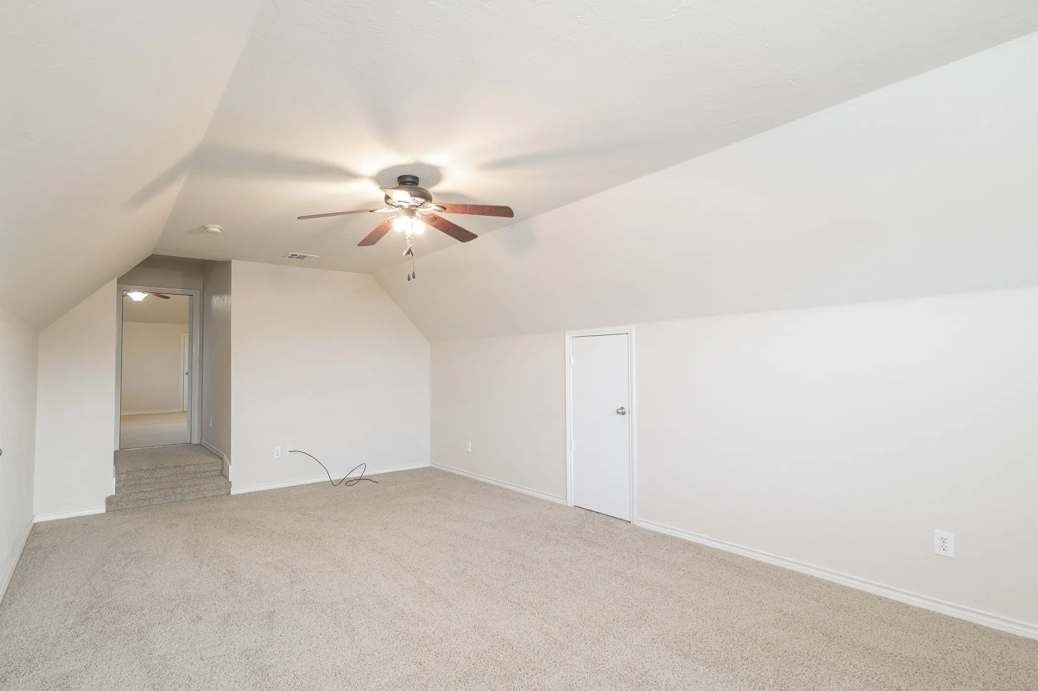 Bonus room featuring ceiling fan, carpet floors, and lofted ceiling