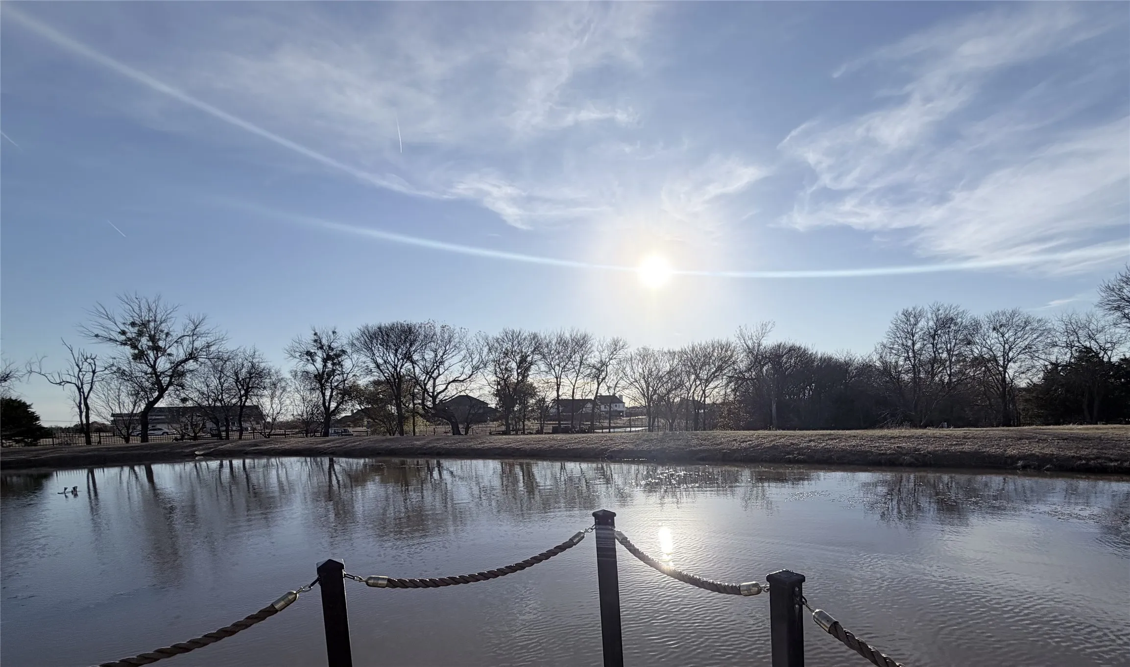 Reflective pond with a dark rope barrier