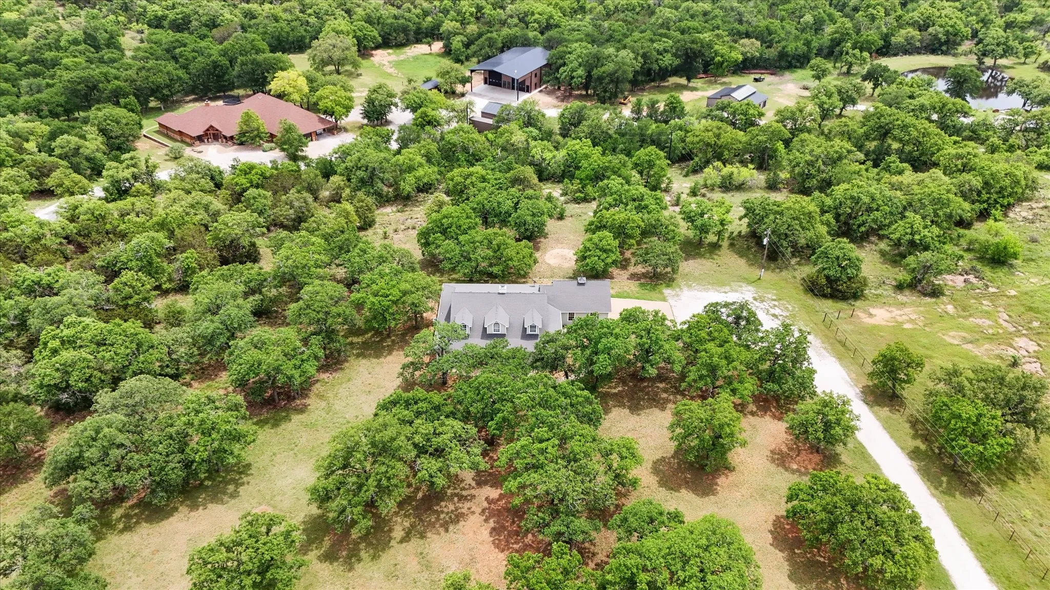Expansive acreage featuring abundant mature trees surrounding the main residence