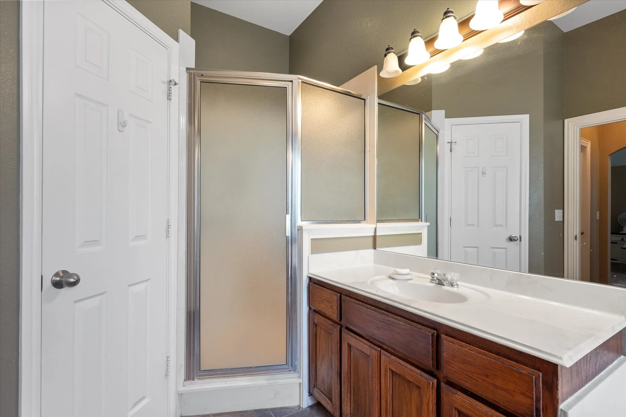 Bathroom vanity with an integrated sink and wood-finish cabinetry