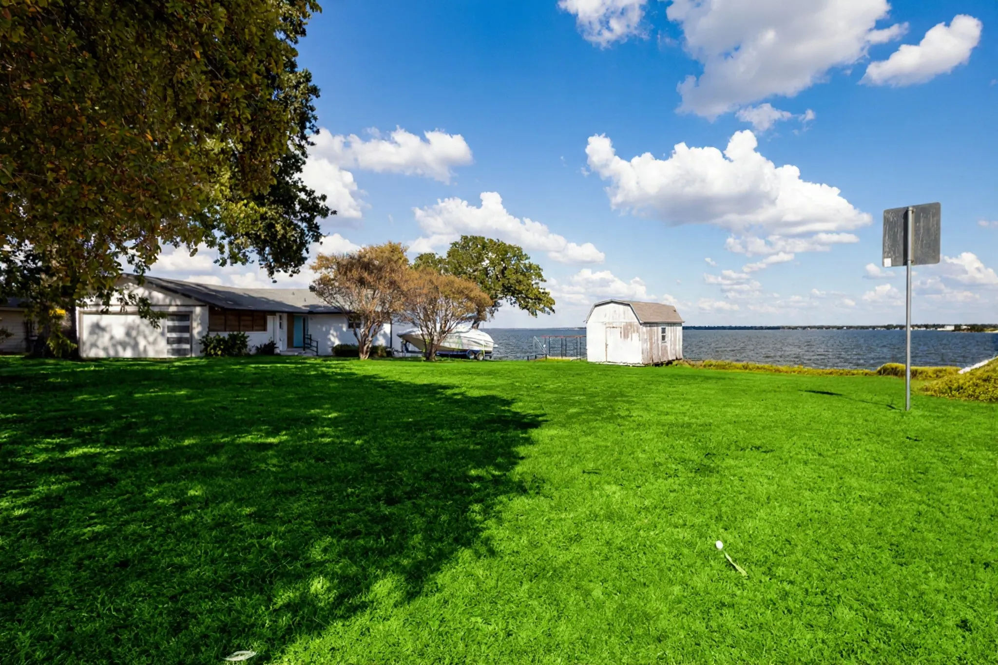 Expansive green lawn with water frontage