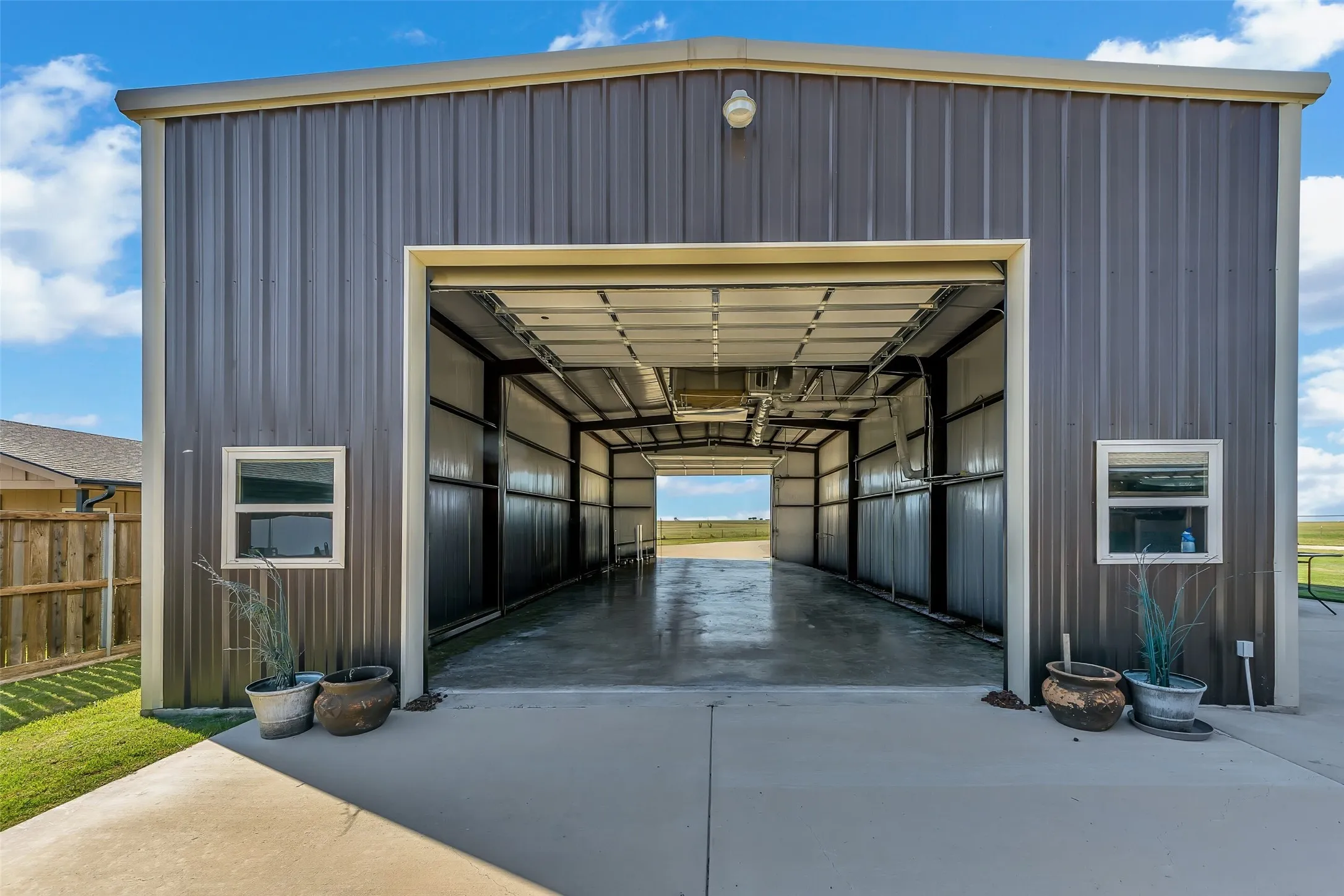 Spacious metal building featuring a large open bay with a roll-up door