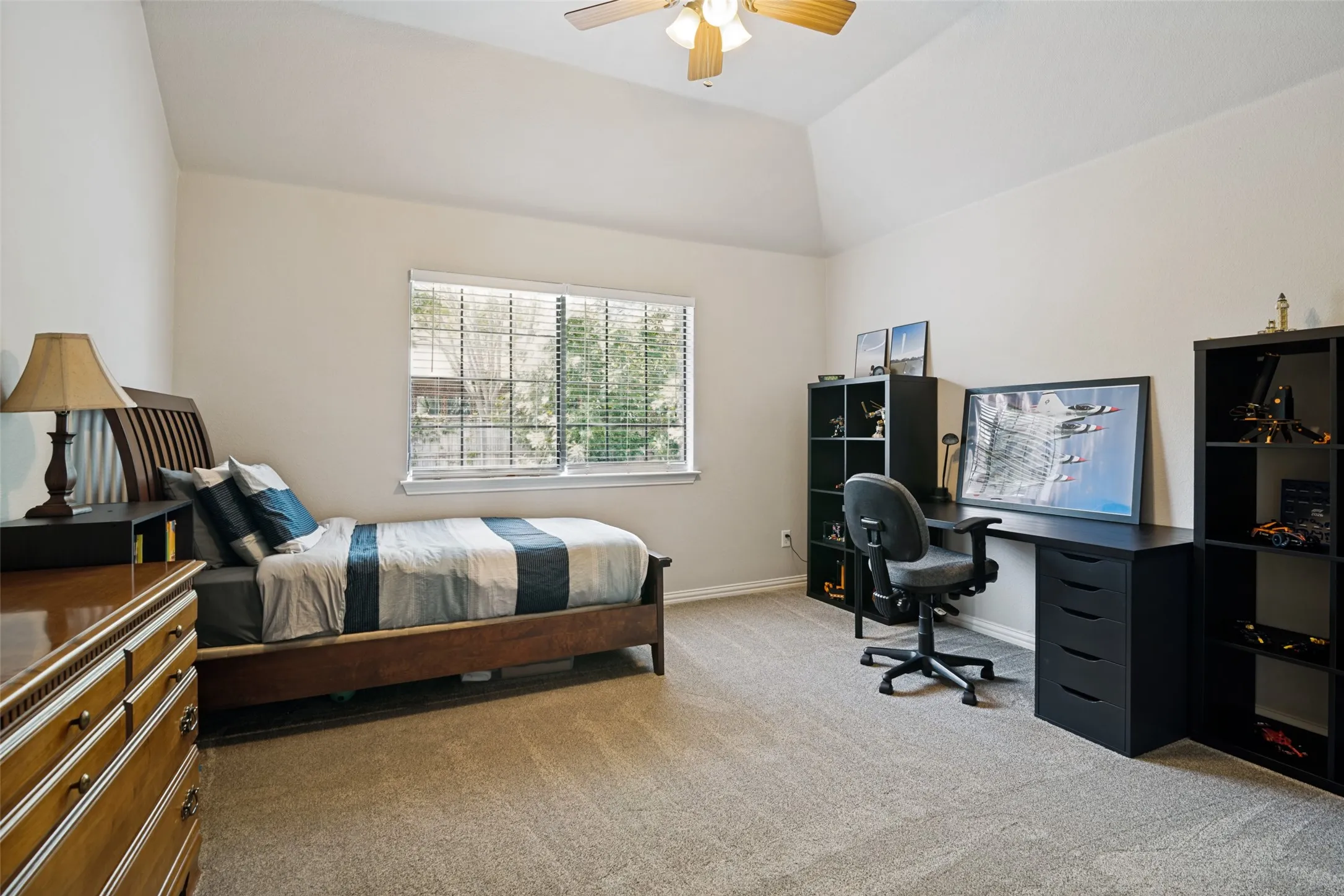 Vaulted ceilings with a ceiling fan, window with blinds, and neutral carpeting