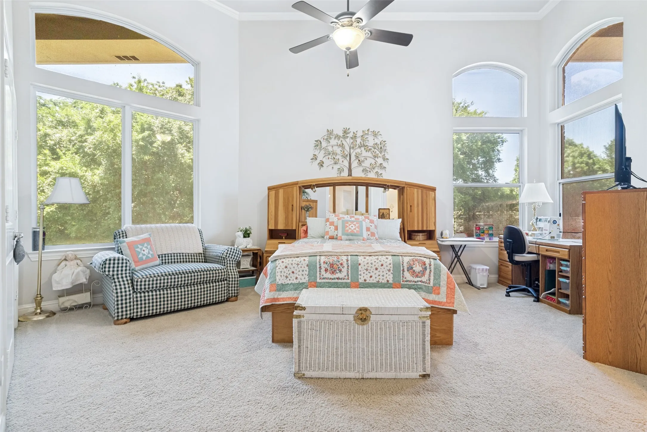 Spacious room featuring vaulted ceilings, light carpeting, and white walls
