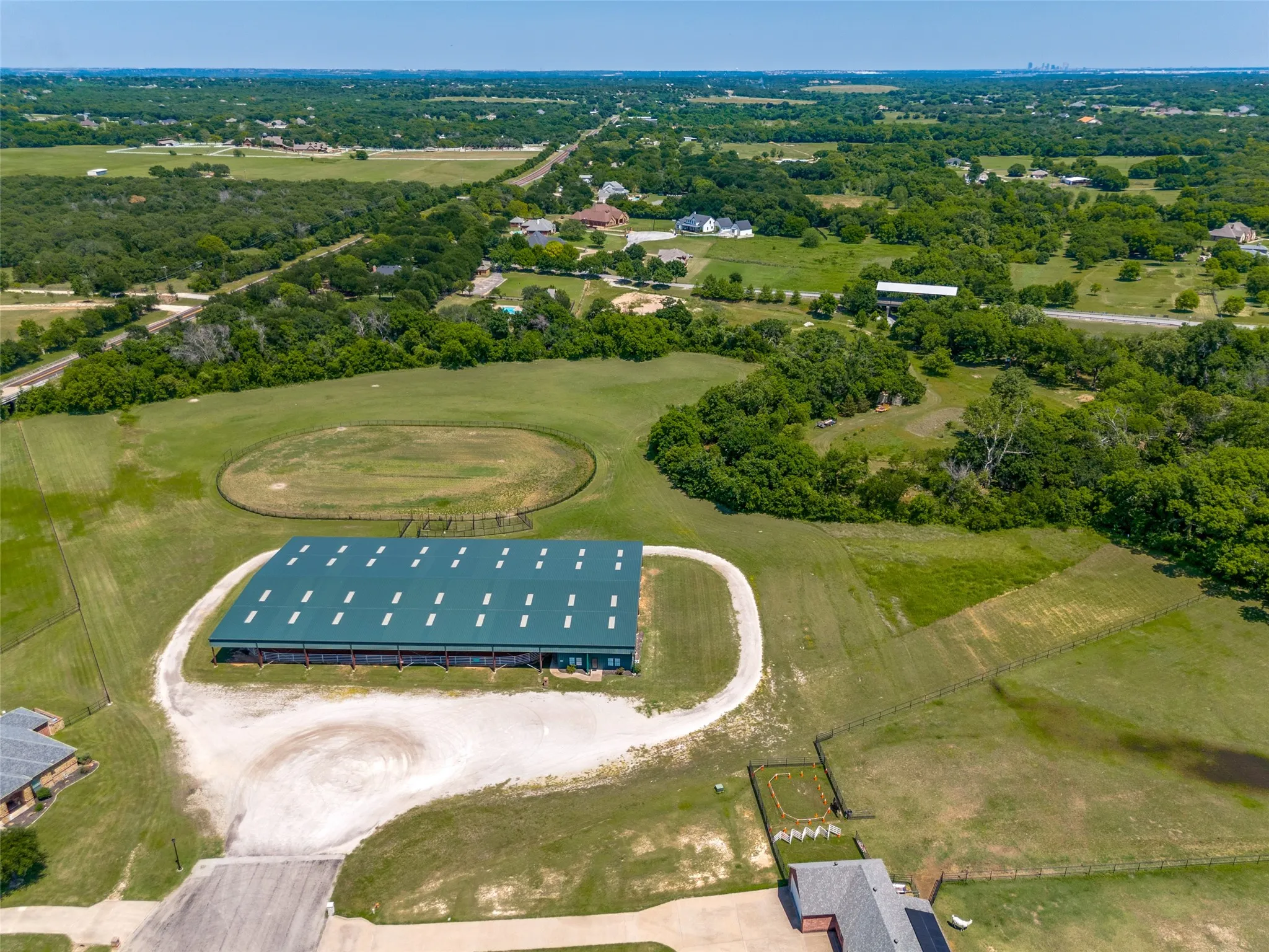 HOA equestrian facility with covered arena, uncovered arena and a small event room with kitchen area.