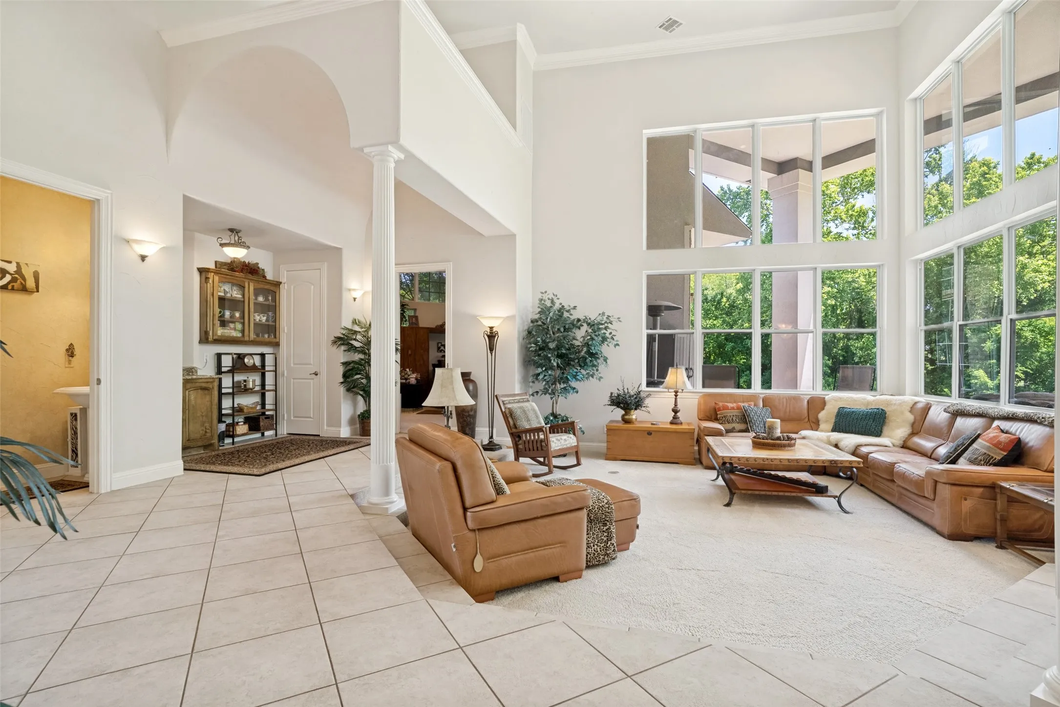 Spacious living area featuring soaring ceilings and extensive window walls