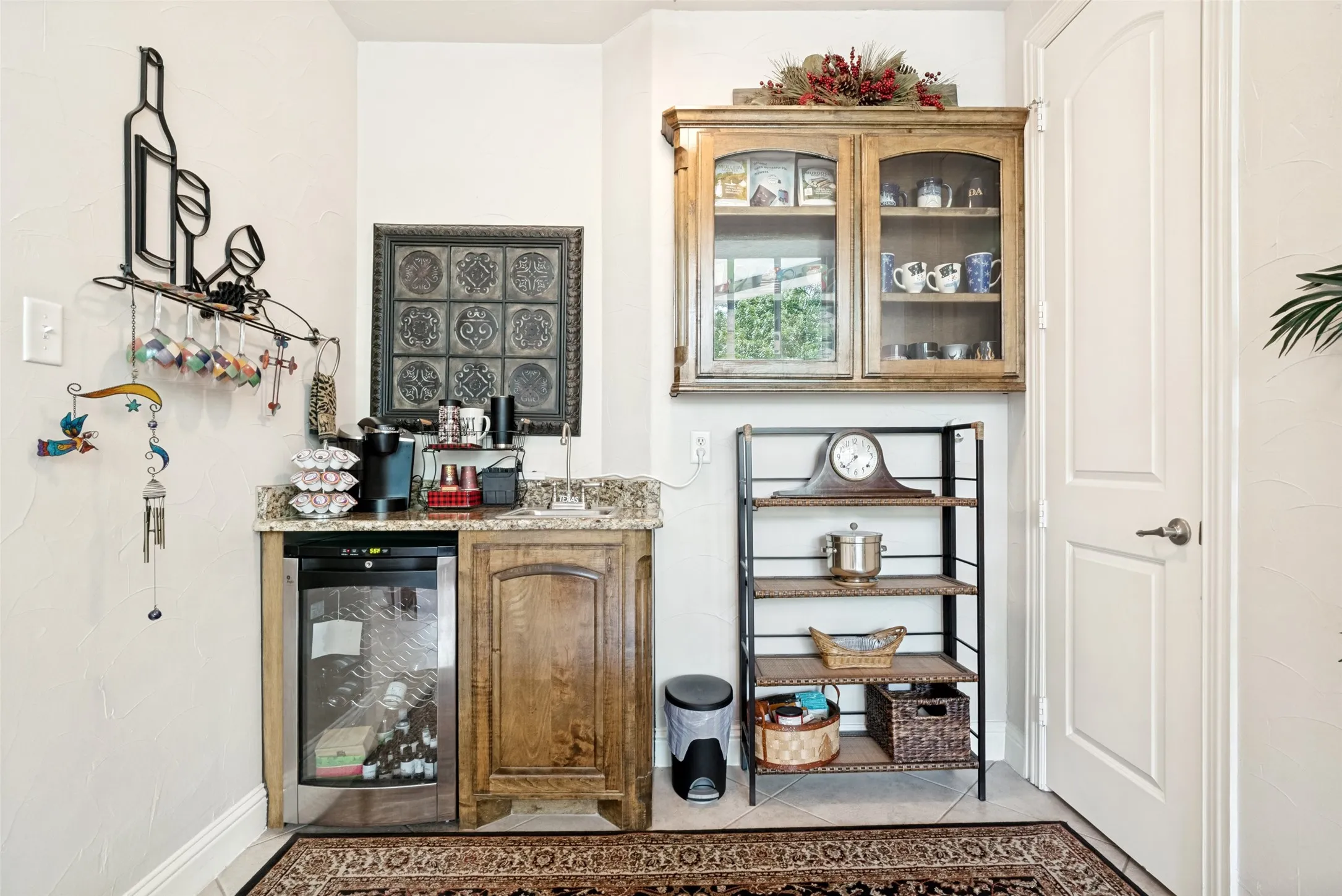 Built-in beverage station featuring a granite countertop, under-counter beverage cooler, and custom wood cabinetry