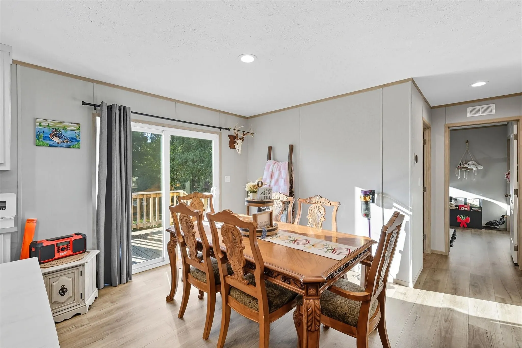 Dining space featuring light wood-style flooring, recessed lighting, and ornamental molding