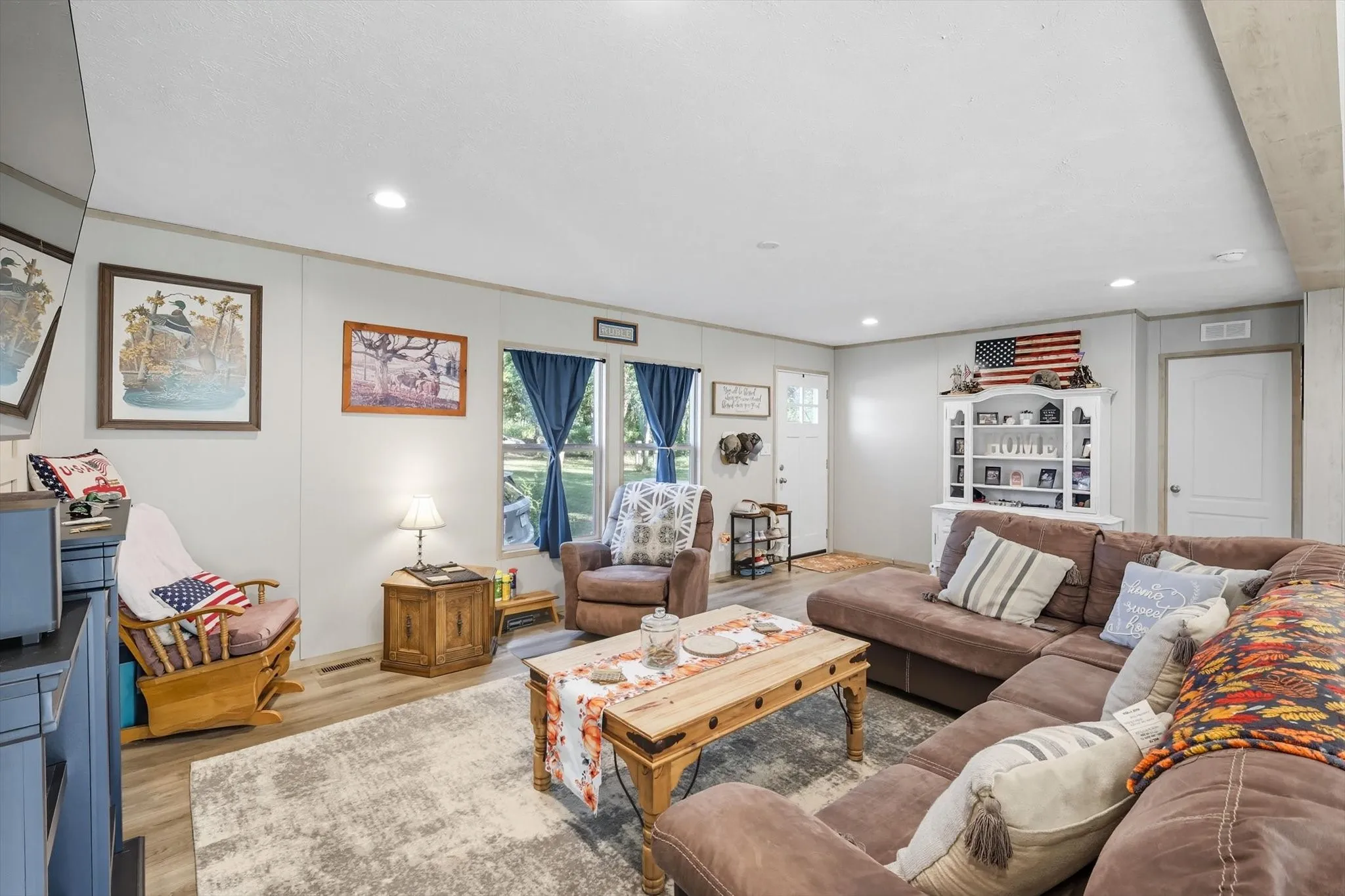 Living room featuring wood finished floors and recessed lighting