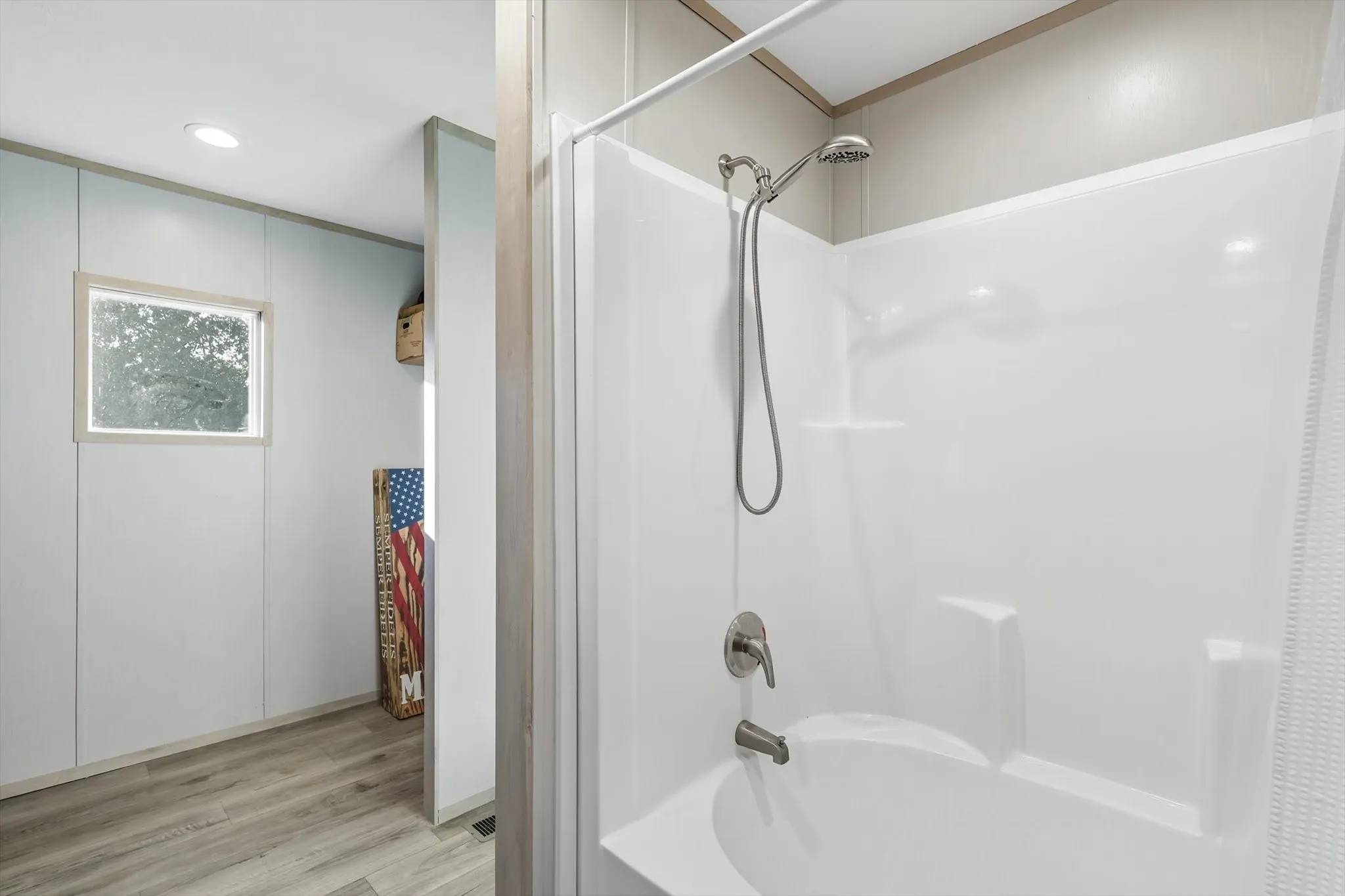 Full bath with shower / bath combination with curtain, light wood-type flooring, and recessed lighting