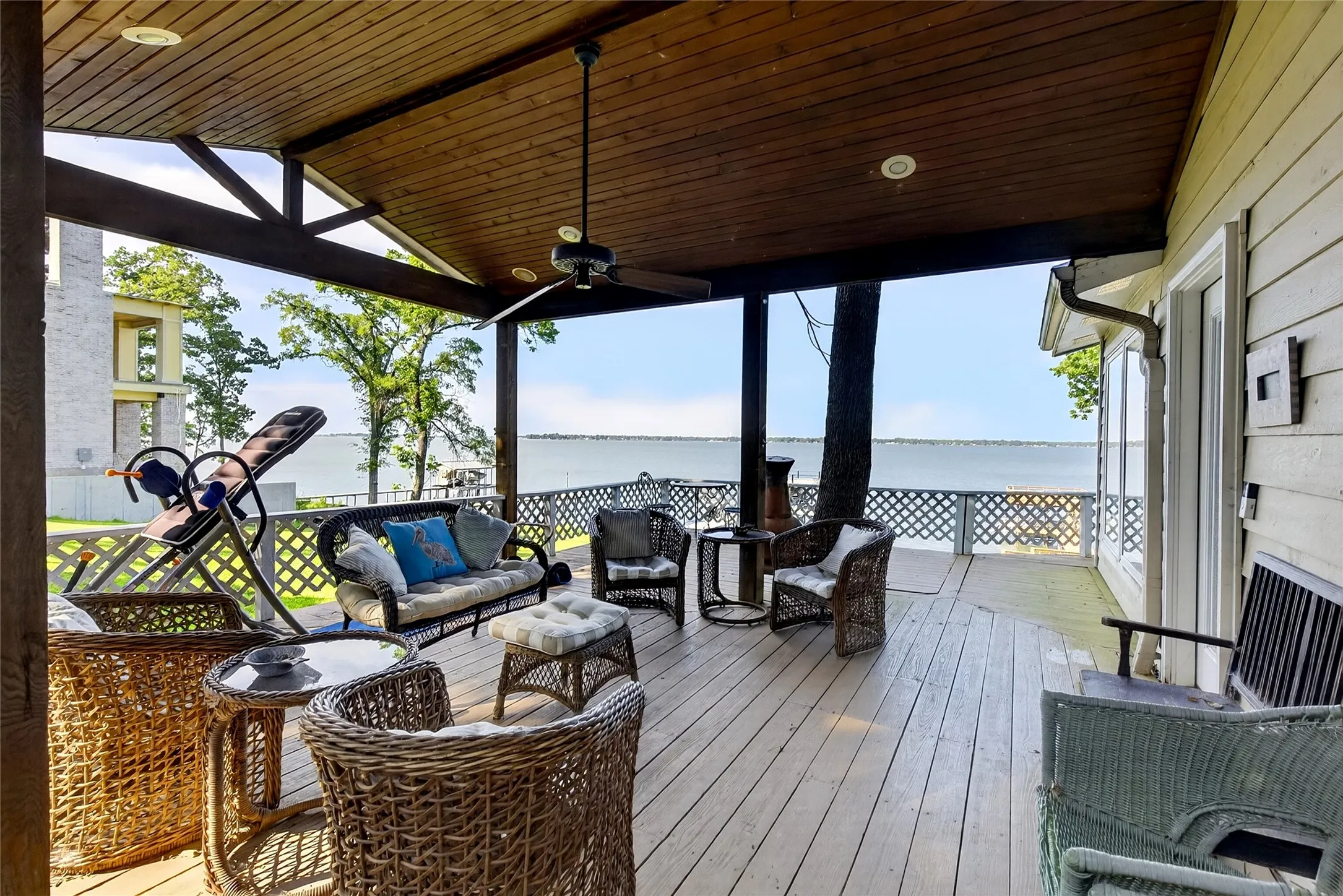 A big covered lakeside porch is a necessity for a lake home.  Spacious covered outdoor deck to enjoy the lake breezes, and a ceiling fan with integrated lighting