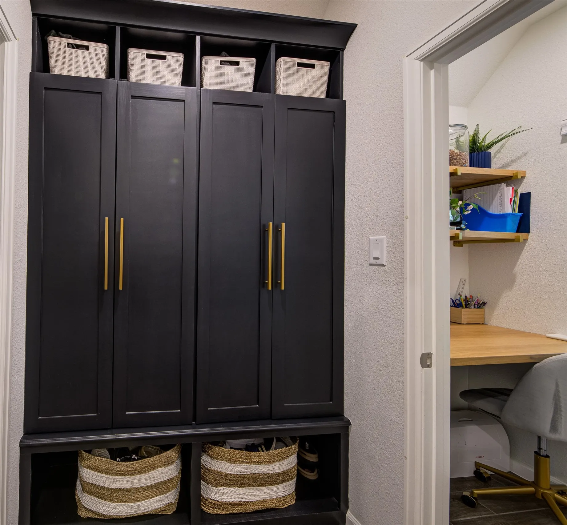 View of the mud room and office nook with soft close cabinetry and built in desk and shelves