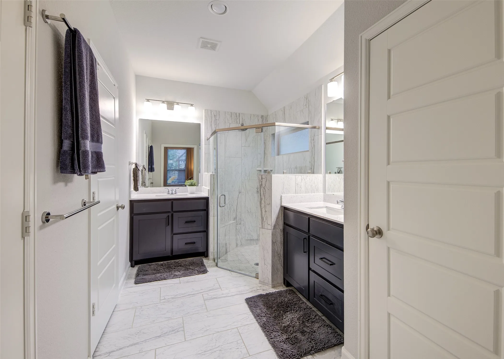 Large primary bath with toilet room and walk-in shower and access to the closet