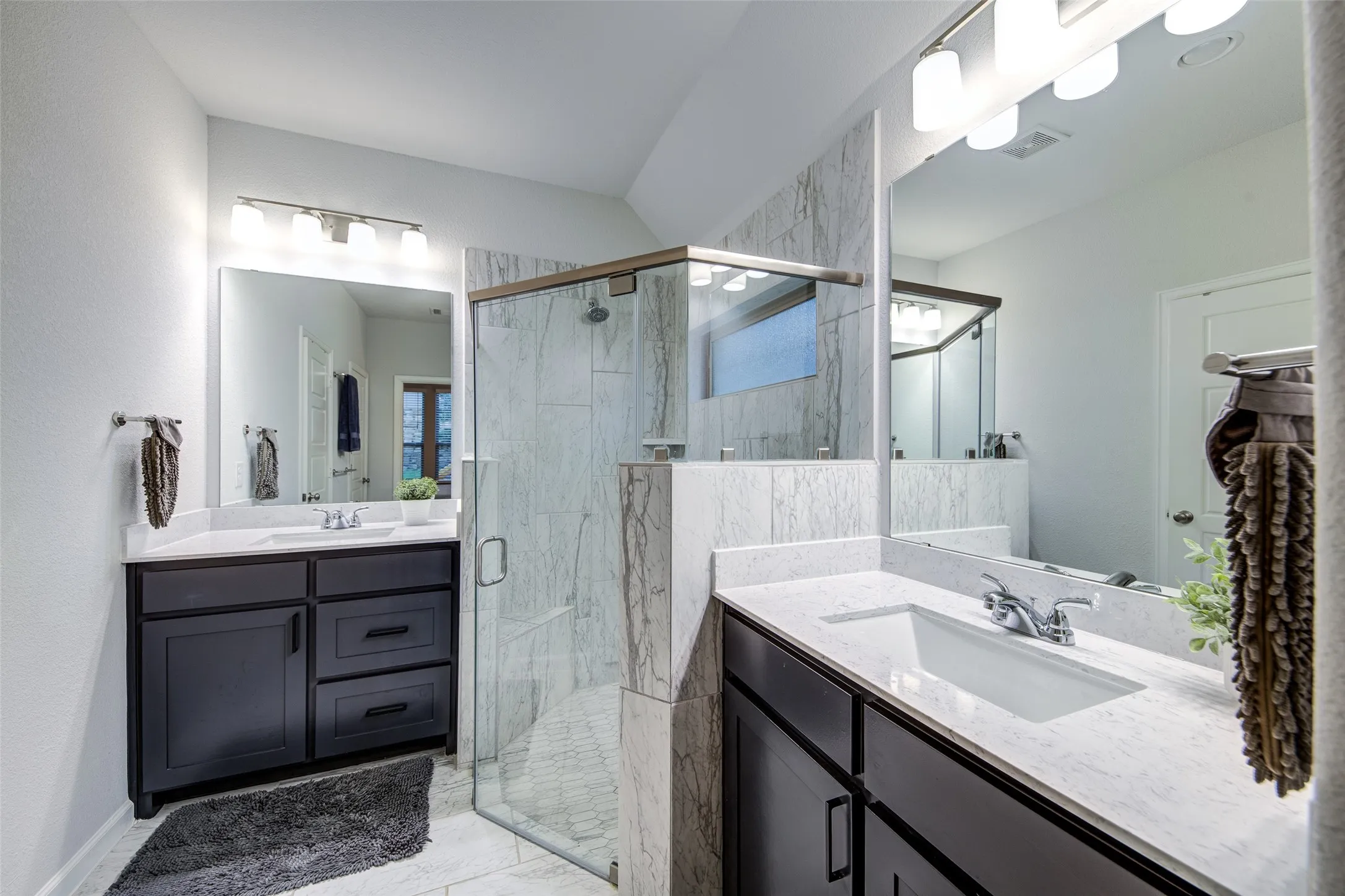 Quartz countertops with double sinks and walk-in shower