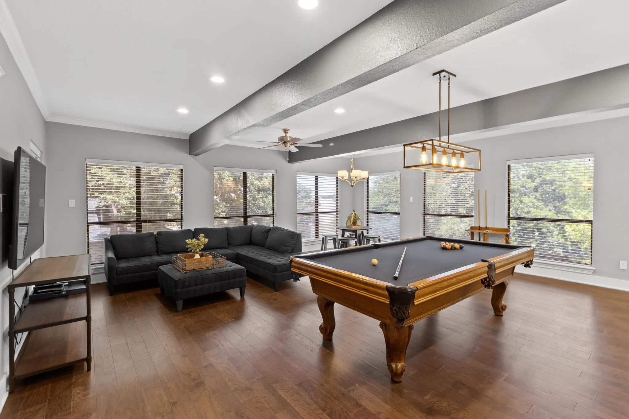 A large Media Room complete with beautiful outside views, solar screens, and tons of space for entertaining.