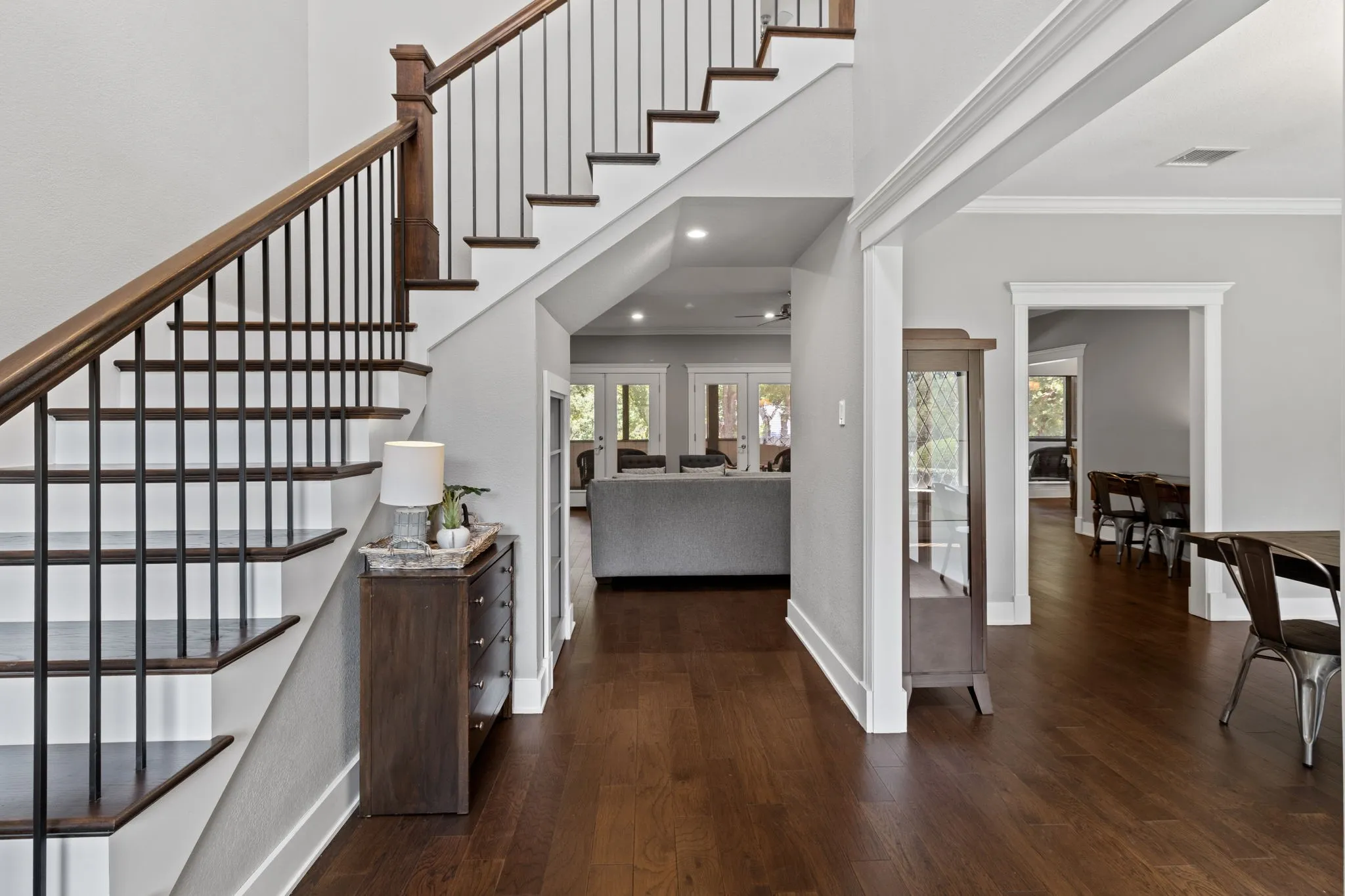 The entryway, featuring a beautiful staircase to the upstairs bedroom and lake-view balcony.