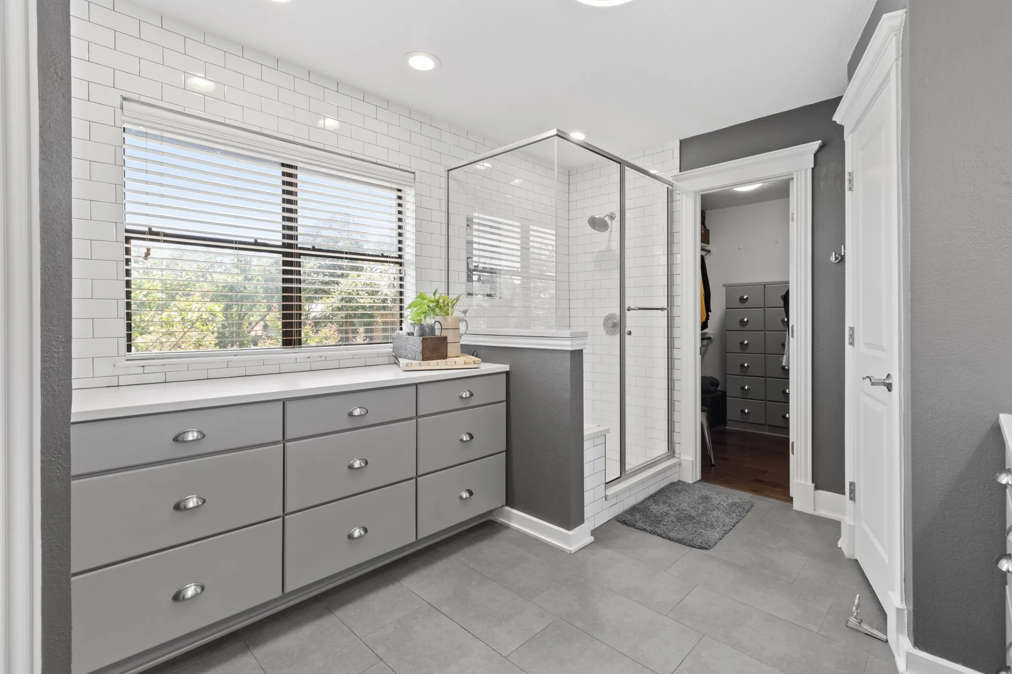Primary Bathroom with first vanity, walk-in closet and toilet
