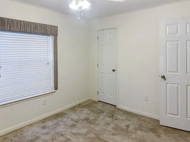 Neutral-toned carpeting and light-colored walls create a versatile interior