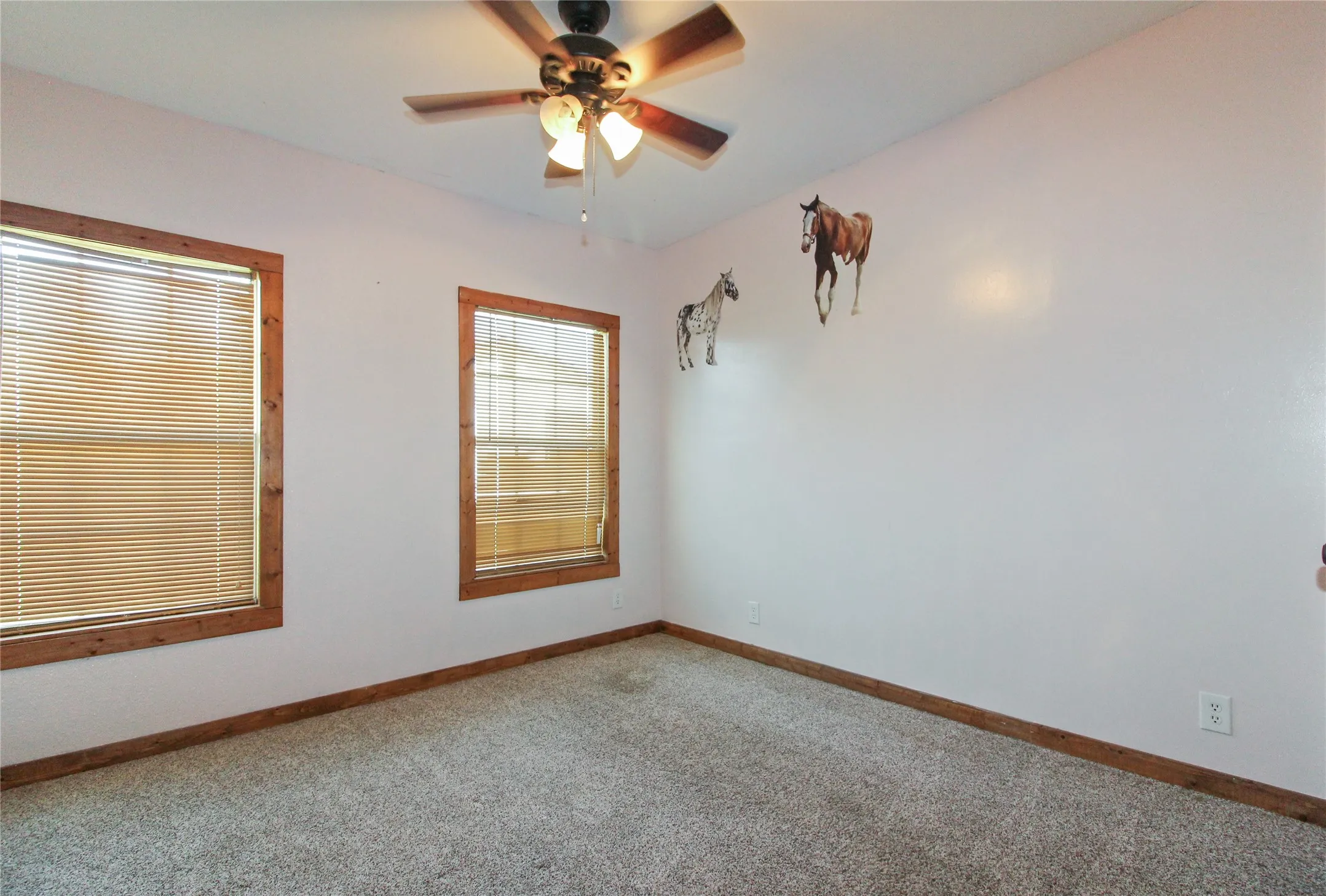 1936  HOUSE Carpeted room featuring dual windows with wood-finish trim and blinds