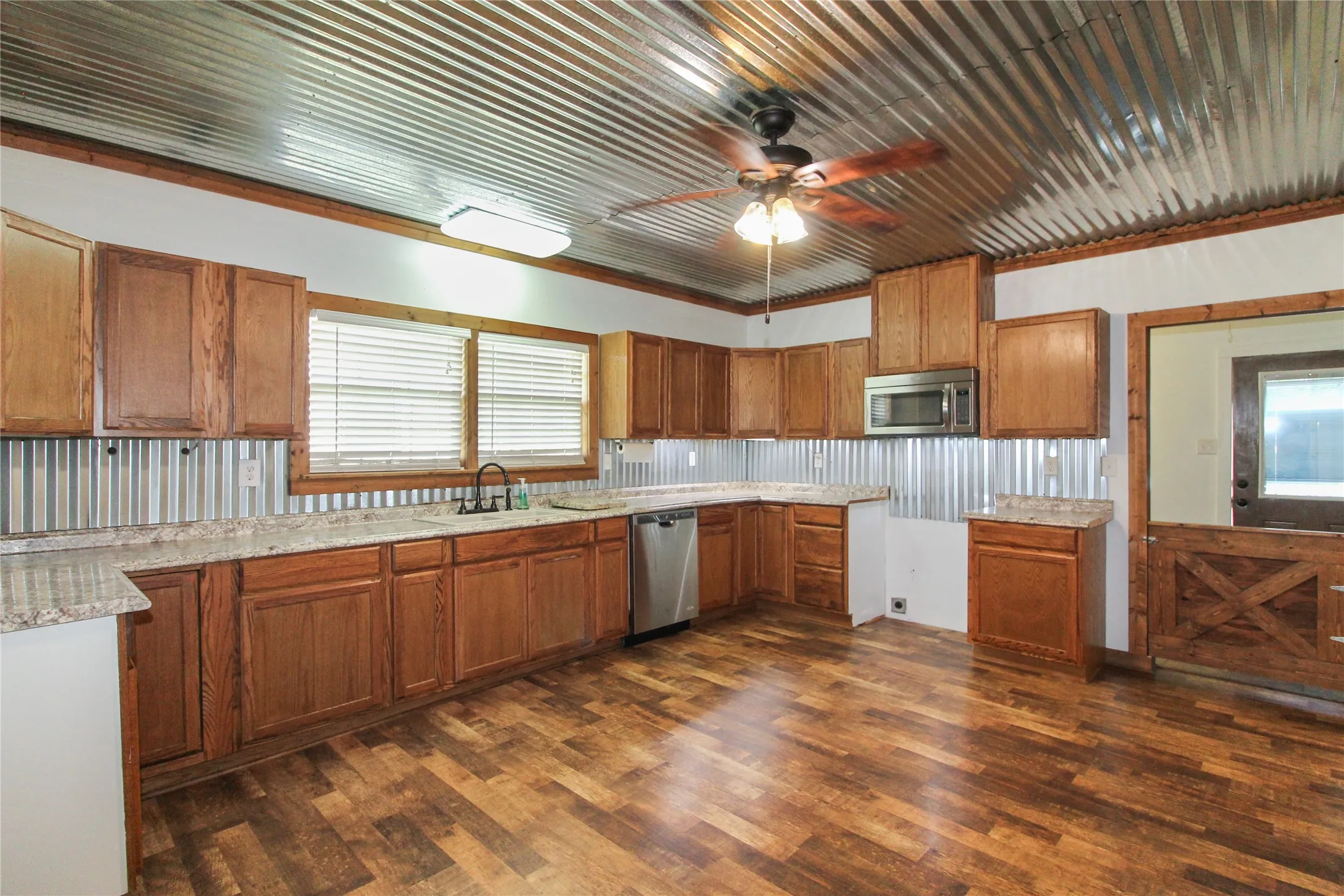 1936  HOUSE Kitchen featuring wood-finish flooring, oak cabinetry, and granite-style countertops