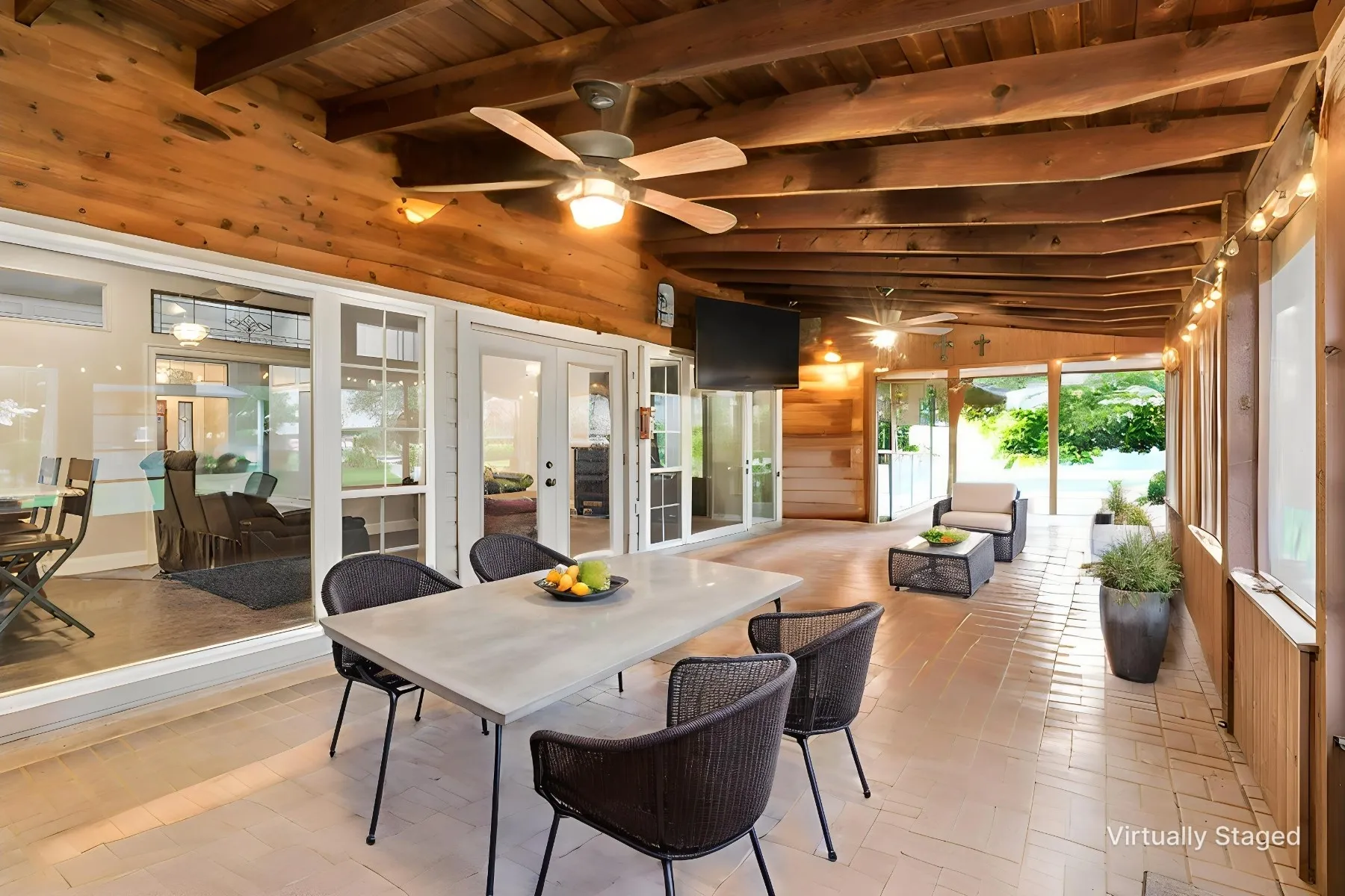 Screened in porch featuring pave stones as the flooring.