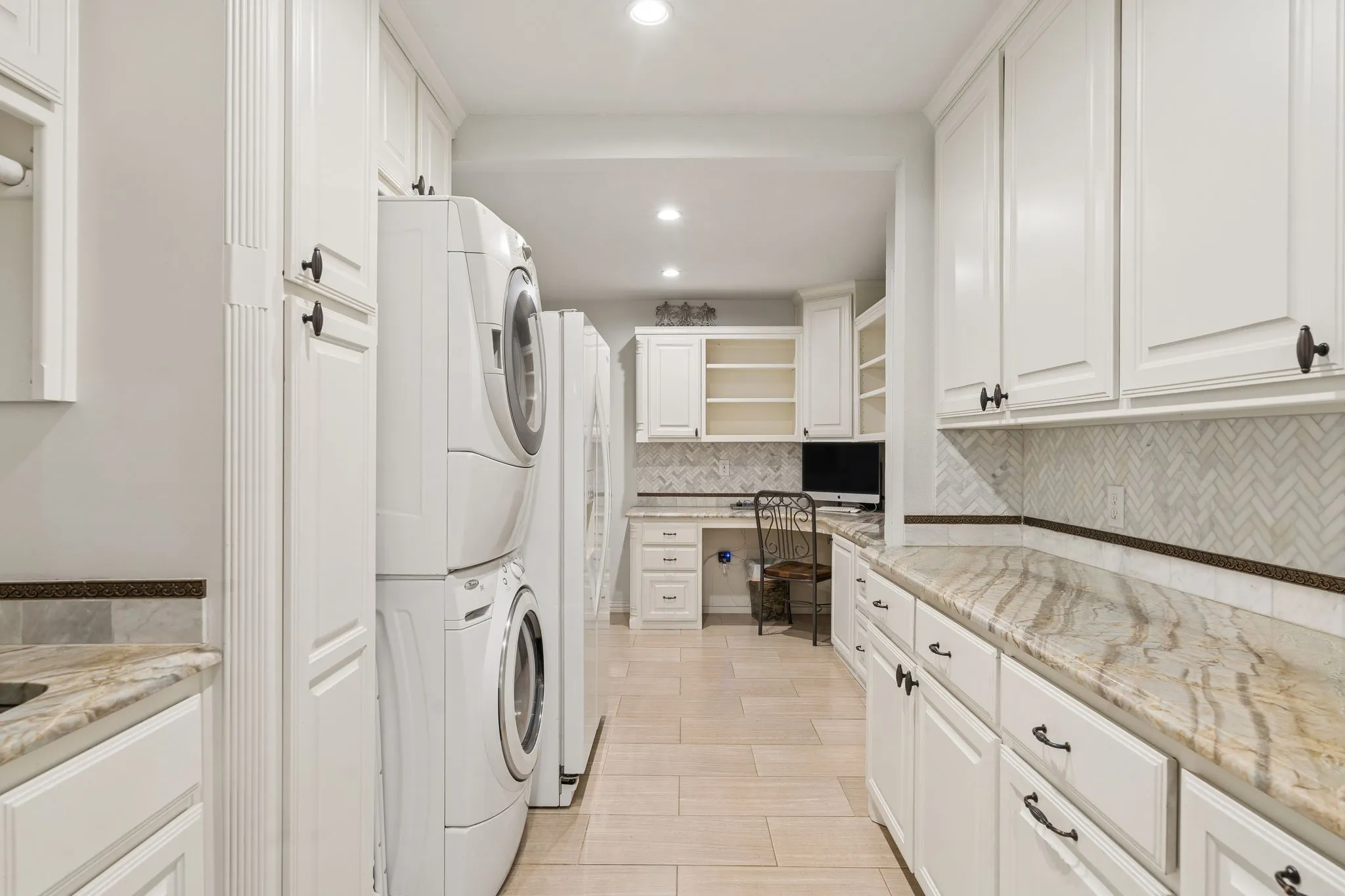 Expanded Laundry room with granite counters and features a built in desk.
