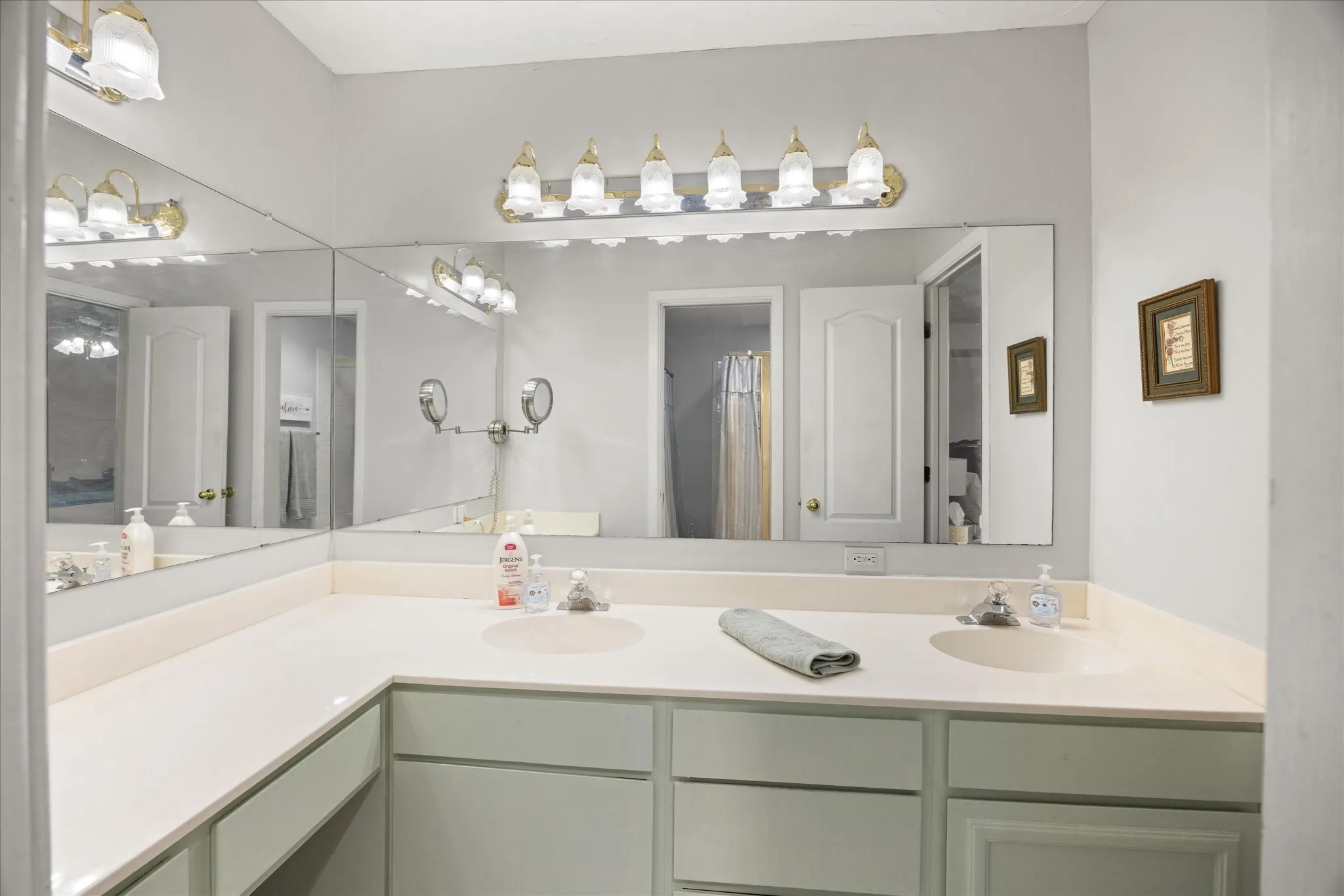 Primary bathroom sink and cabinet area.