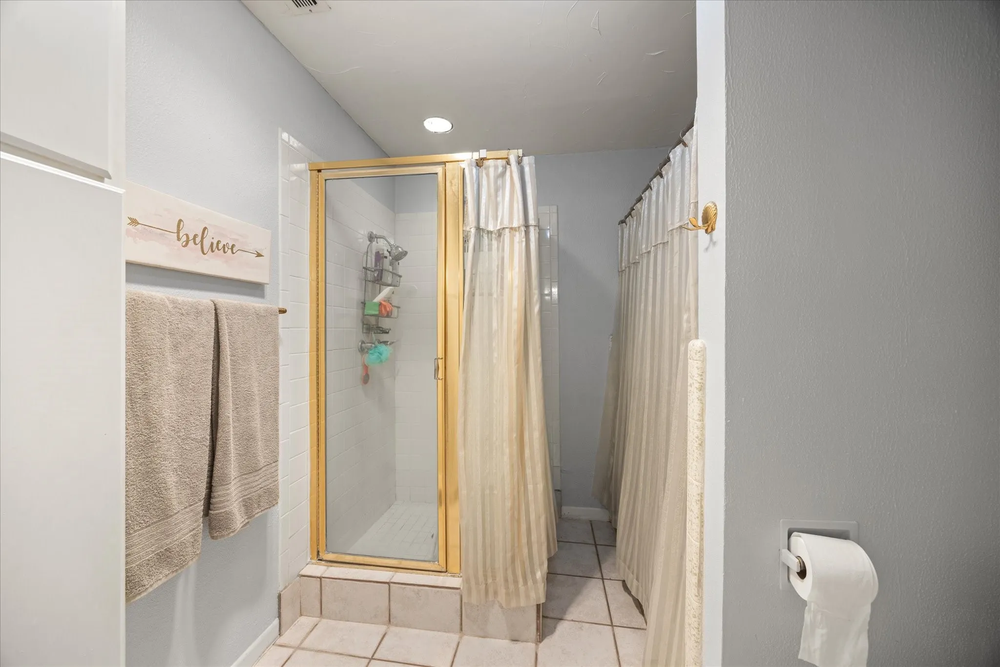 Primary bathroom shower and bath area.