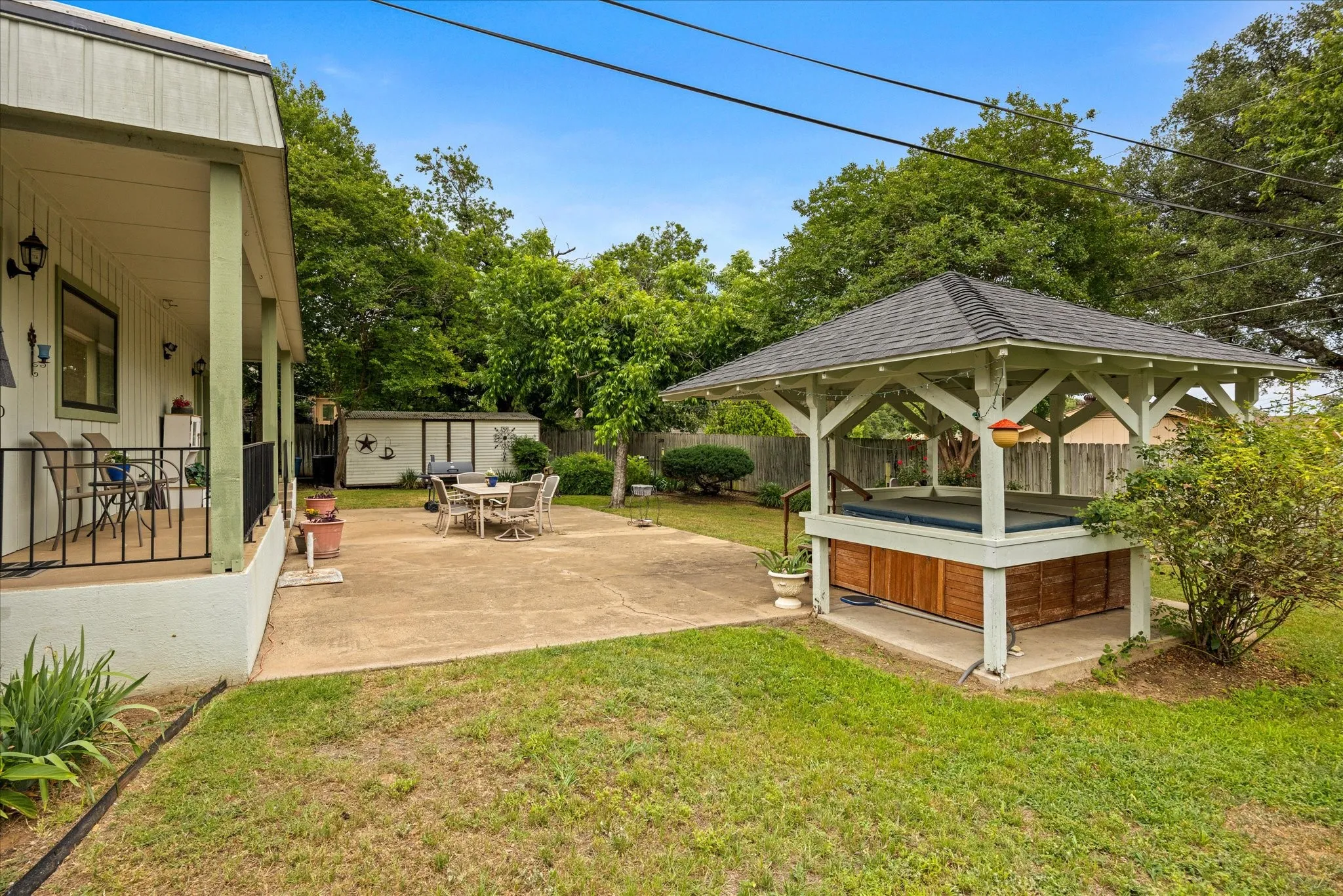 Side view of backyard and patio.  Notice workshop and storage building.
