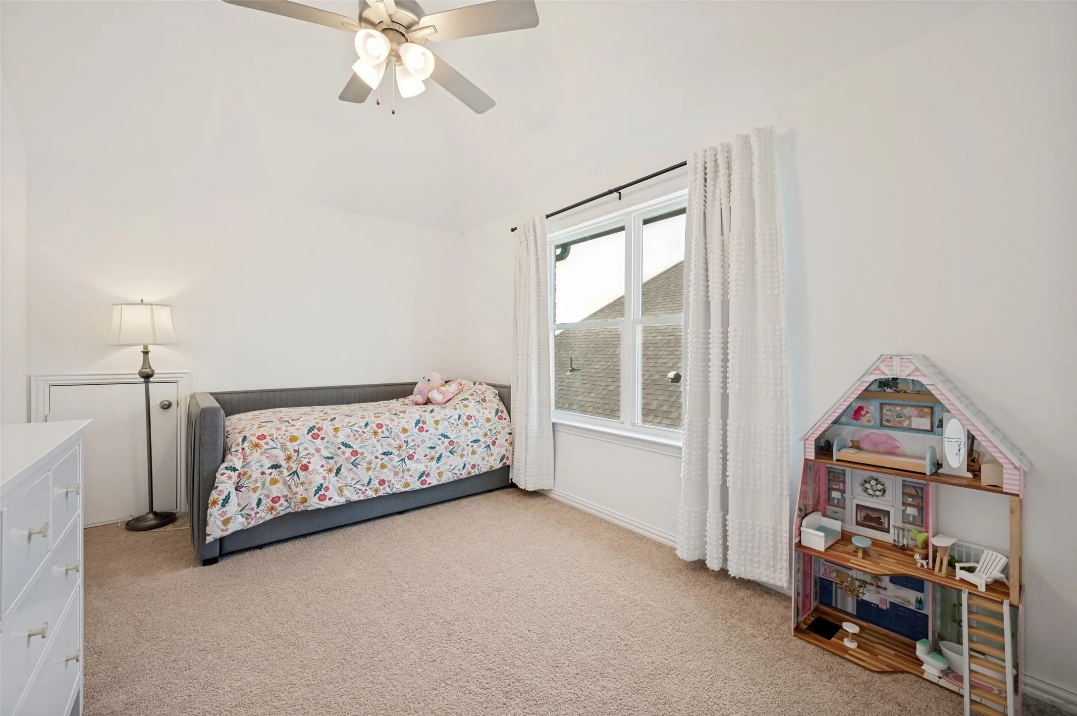 Second floor bedroom exudes natural lighting and has arched heightened ceilings for added charm and space