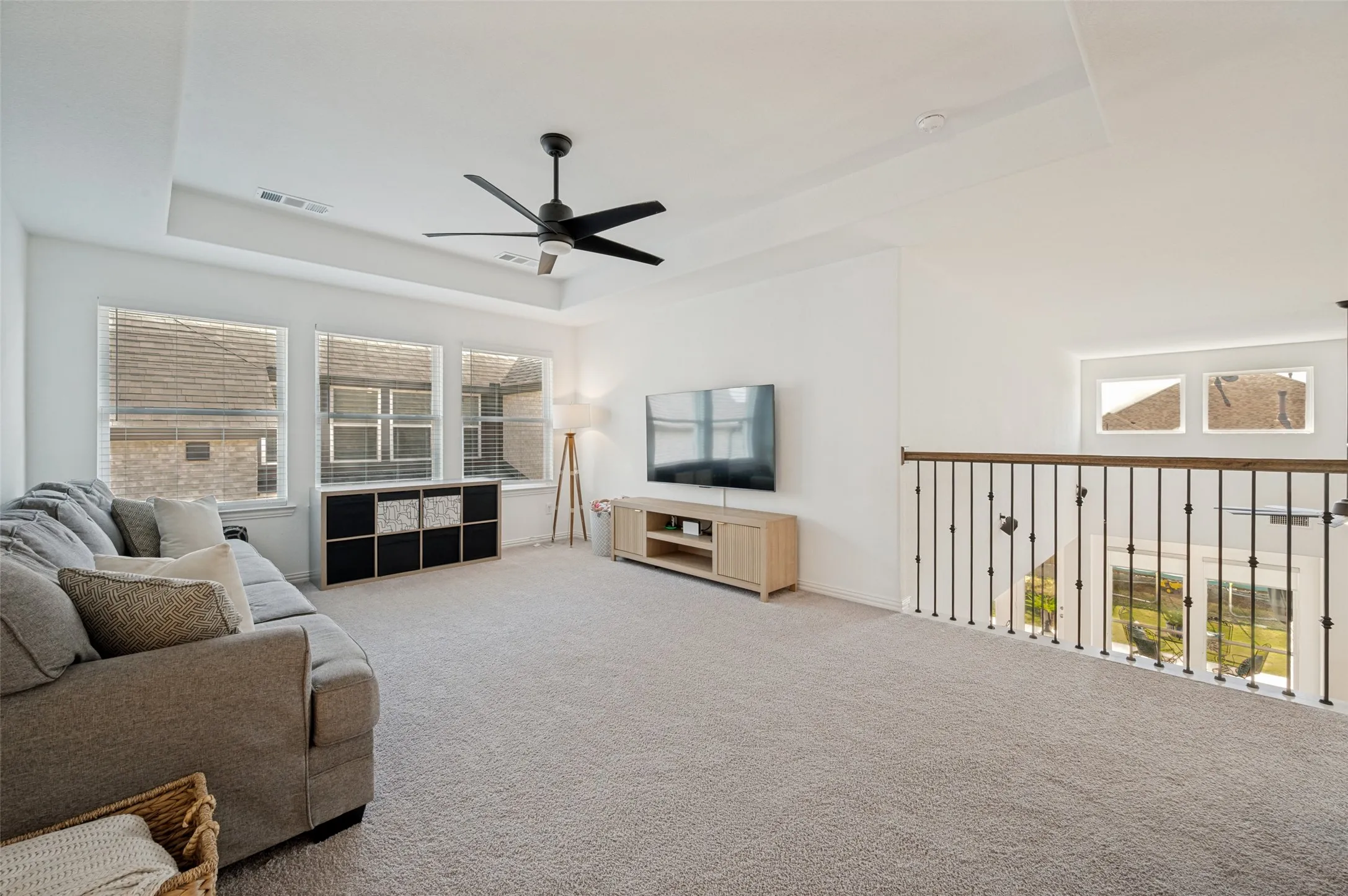 Great open space ready to fulfill your flex space needs! Tray ceilings open this space with natural lighting from windows surrounding this second floor additional living area