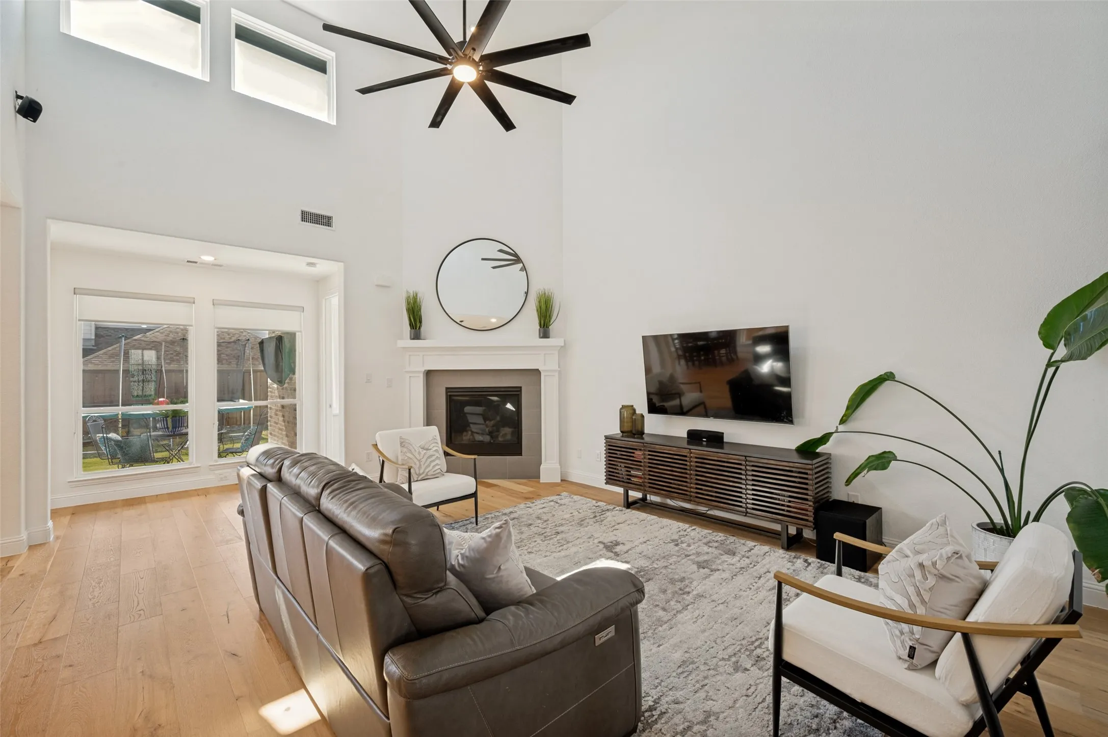 Natural lighting and a cozy fireplace create a comforting atmosphere in this living space