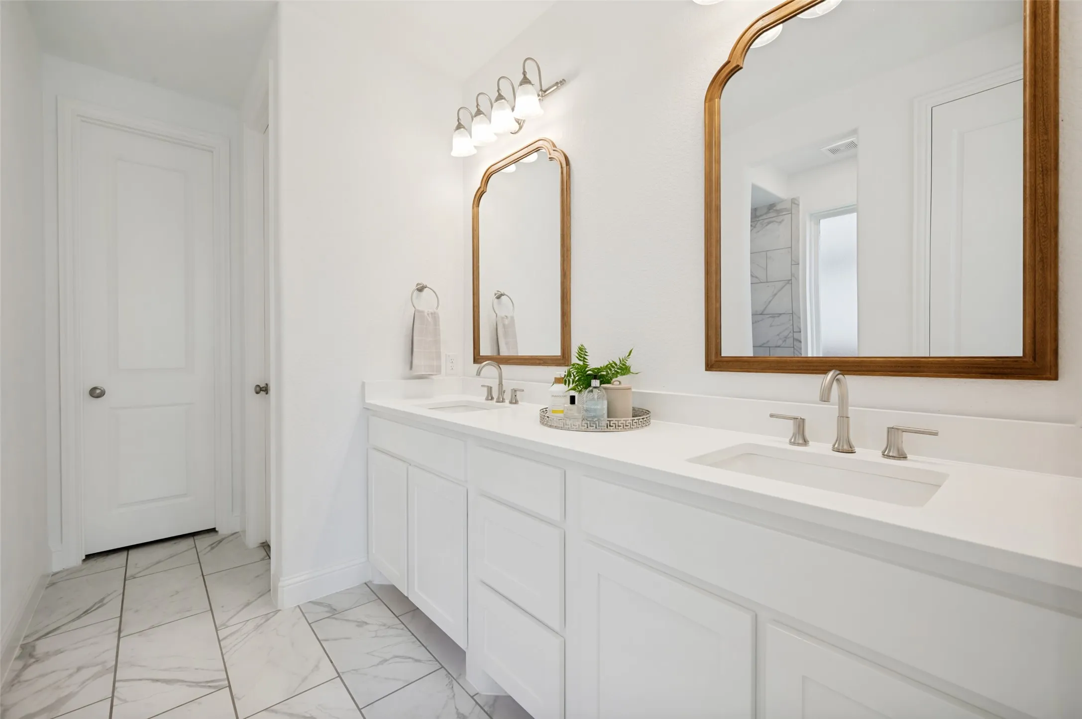 Primary bathroom offers double sinks and ample counter space for each to have deligated prep space for your daily prep routine