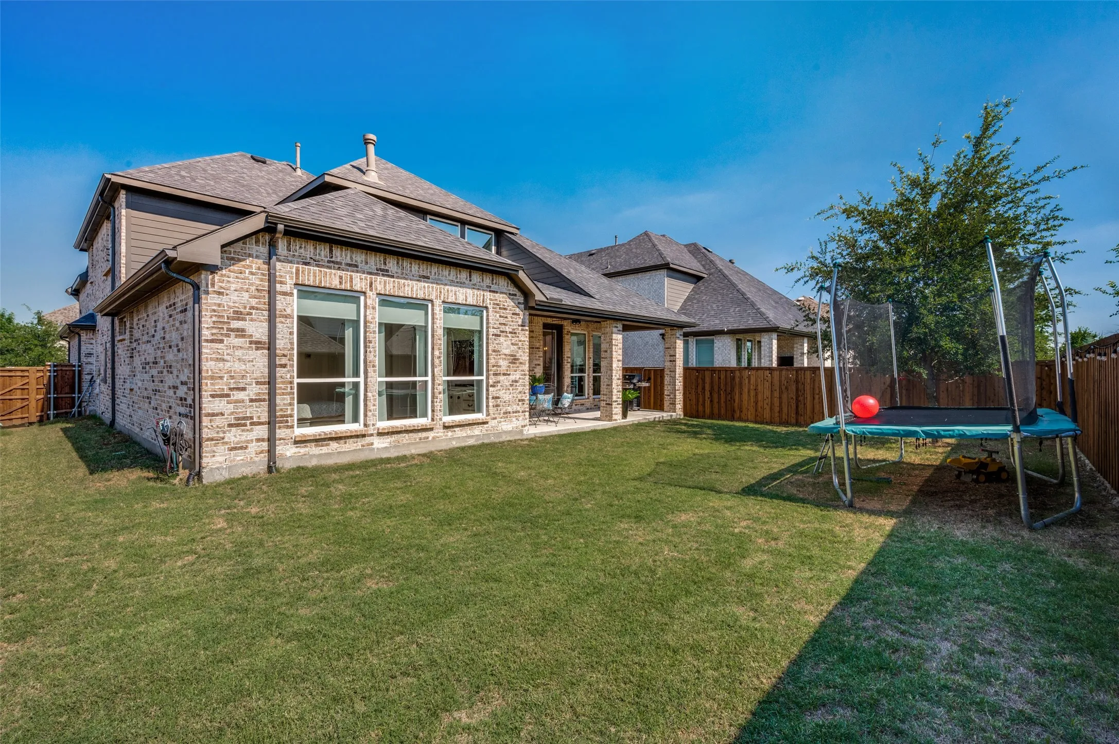 Enclosed backyard providing privacy and safety for pets and play