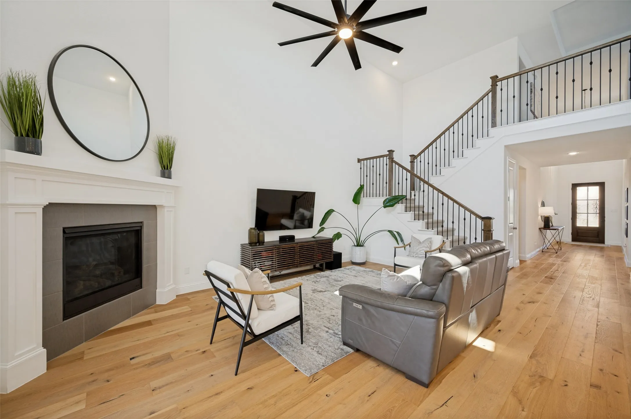 These light interior features combined with light wood flooring are a mix of warmth and modern with a fireplace as a seasonal focal point