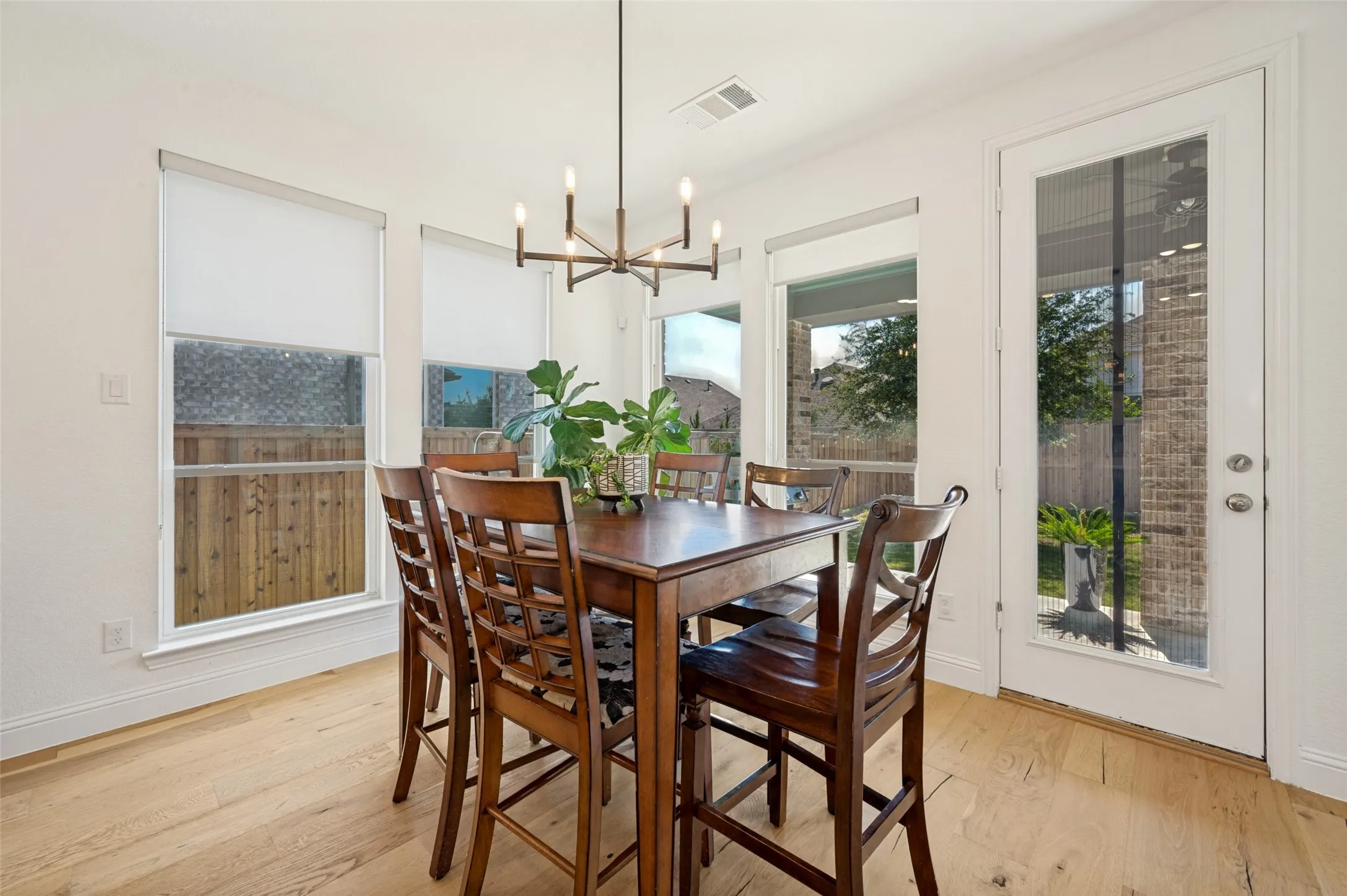 This dining space is adjacent to the kitchen, also providing access to the outdoors with views of the green space to enjoy while dining