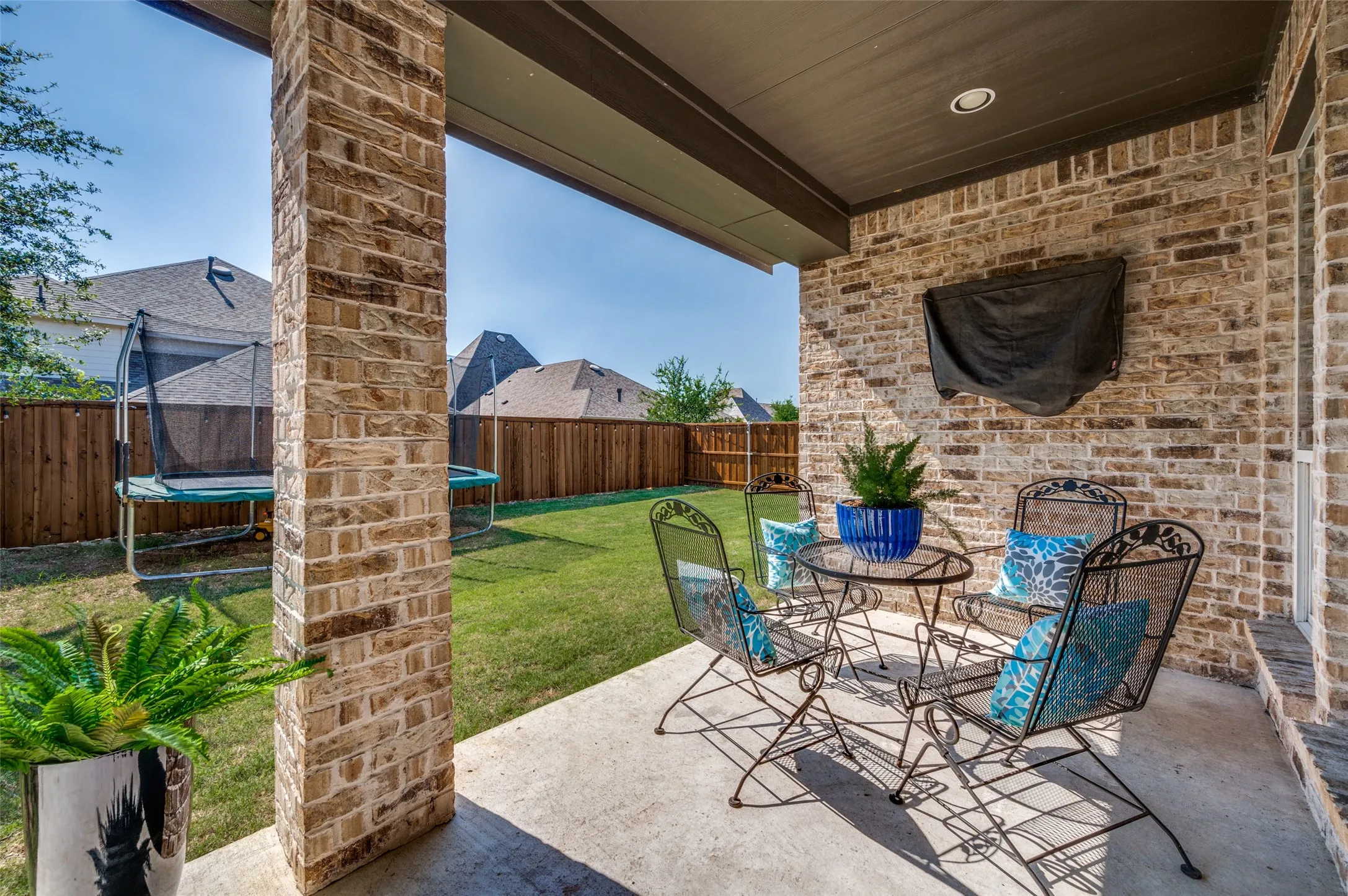 A shaded patio and private wooden fence create the shaded privacy you need to enjoy pets, play, relaxing and unwinding after a long day