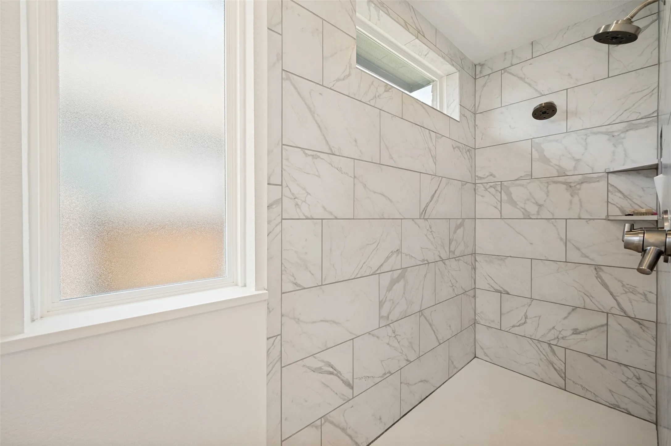 Tiled large walk in shower with dual shower heads are a bonus for this secondary bathroom