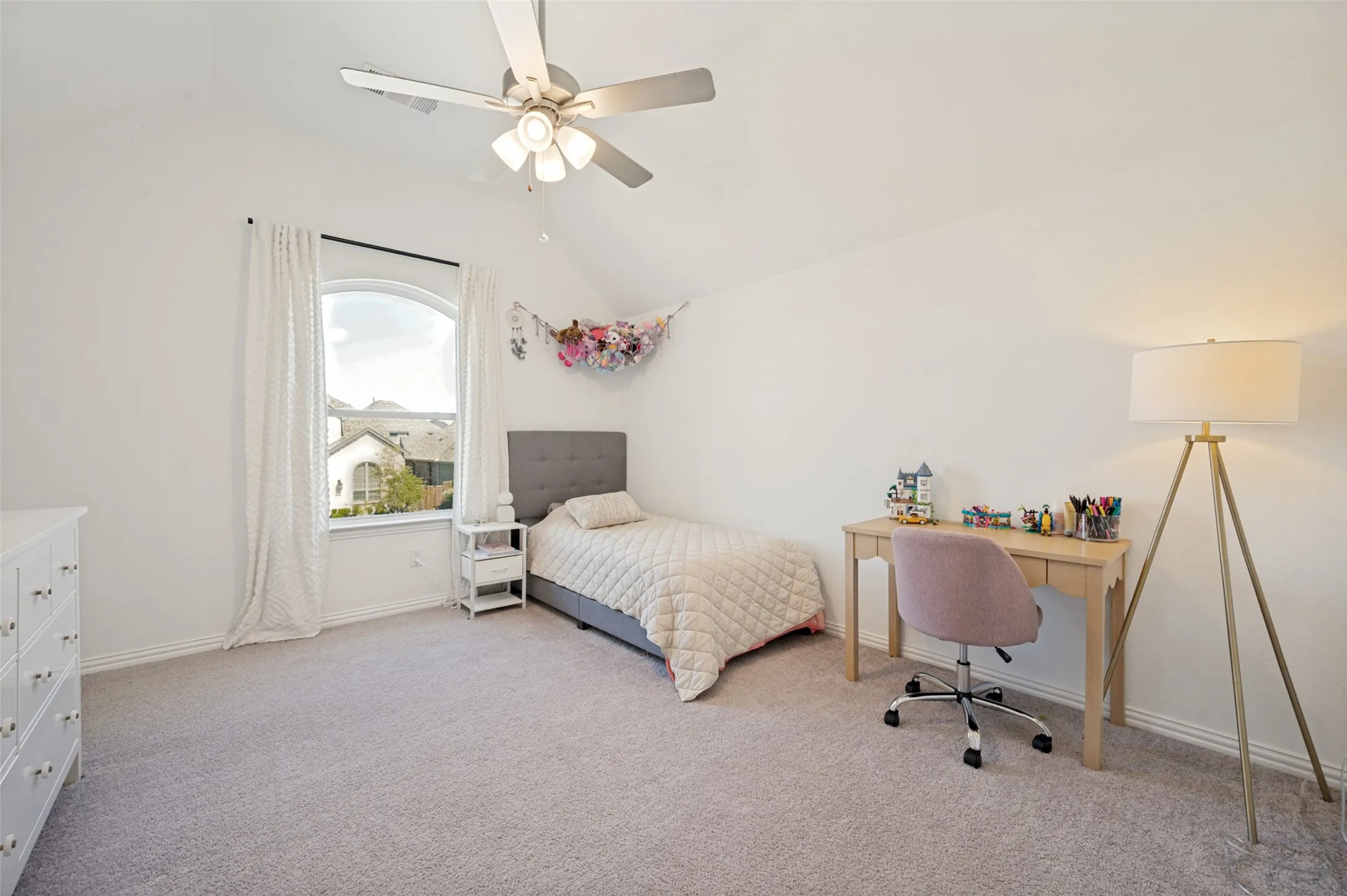 This second floor bedroom is light and bright with natural lighting filling this charming, roomy space