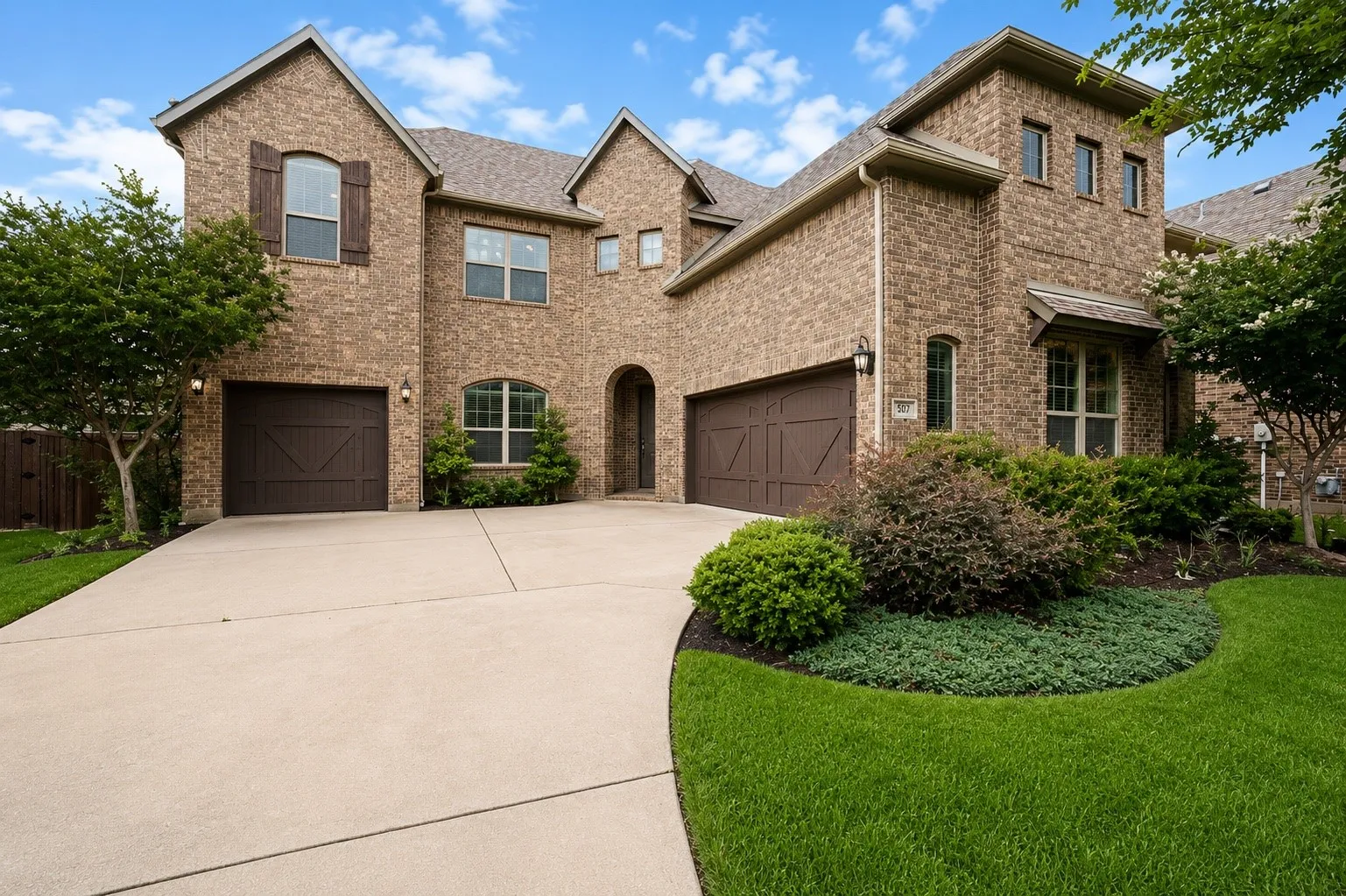 Brick exterior featuring multiple gables and dark wood shutters
